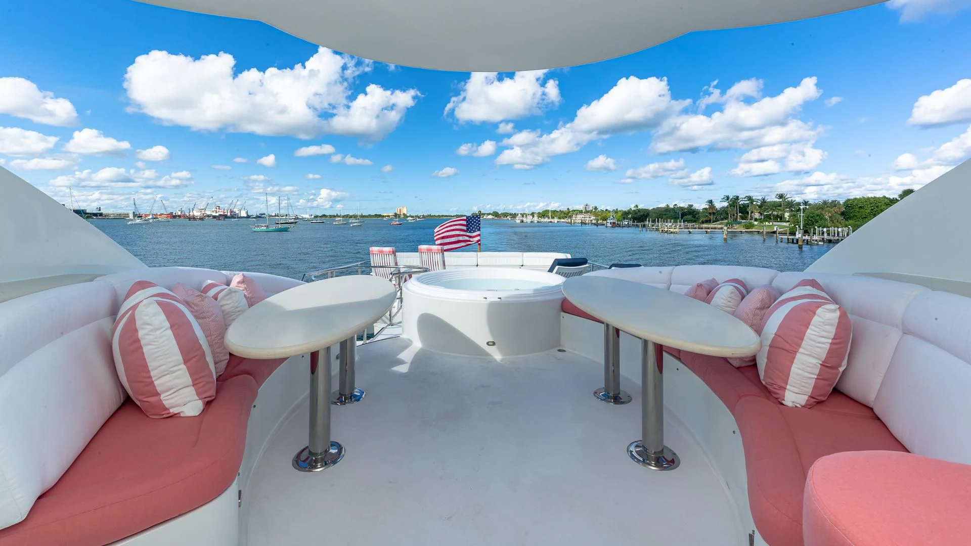 a table and chairs on a balcony overlooking a body of water aboard HOPE FLOATS Yacht for Sale