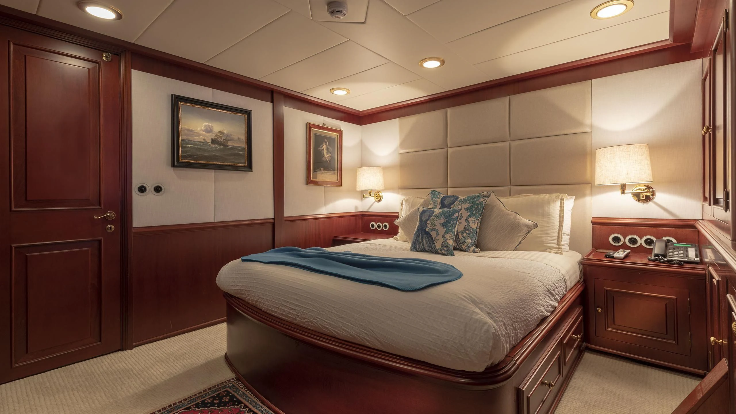 a bedroom with a bed and a desk aboard MONTREVEL Yacht for Sale