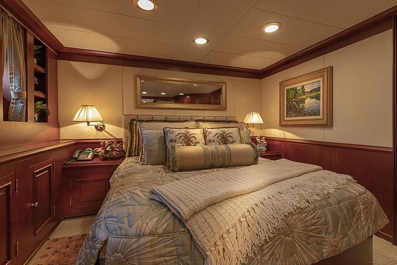 a bedroom with a bed and a desk aboard MONTREVEL Yacht for Sale