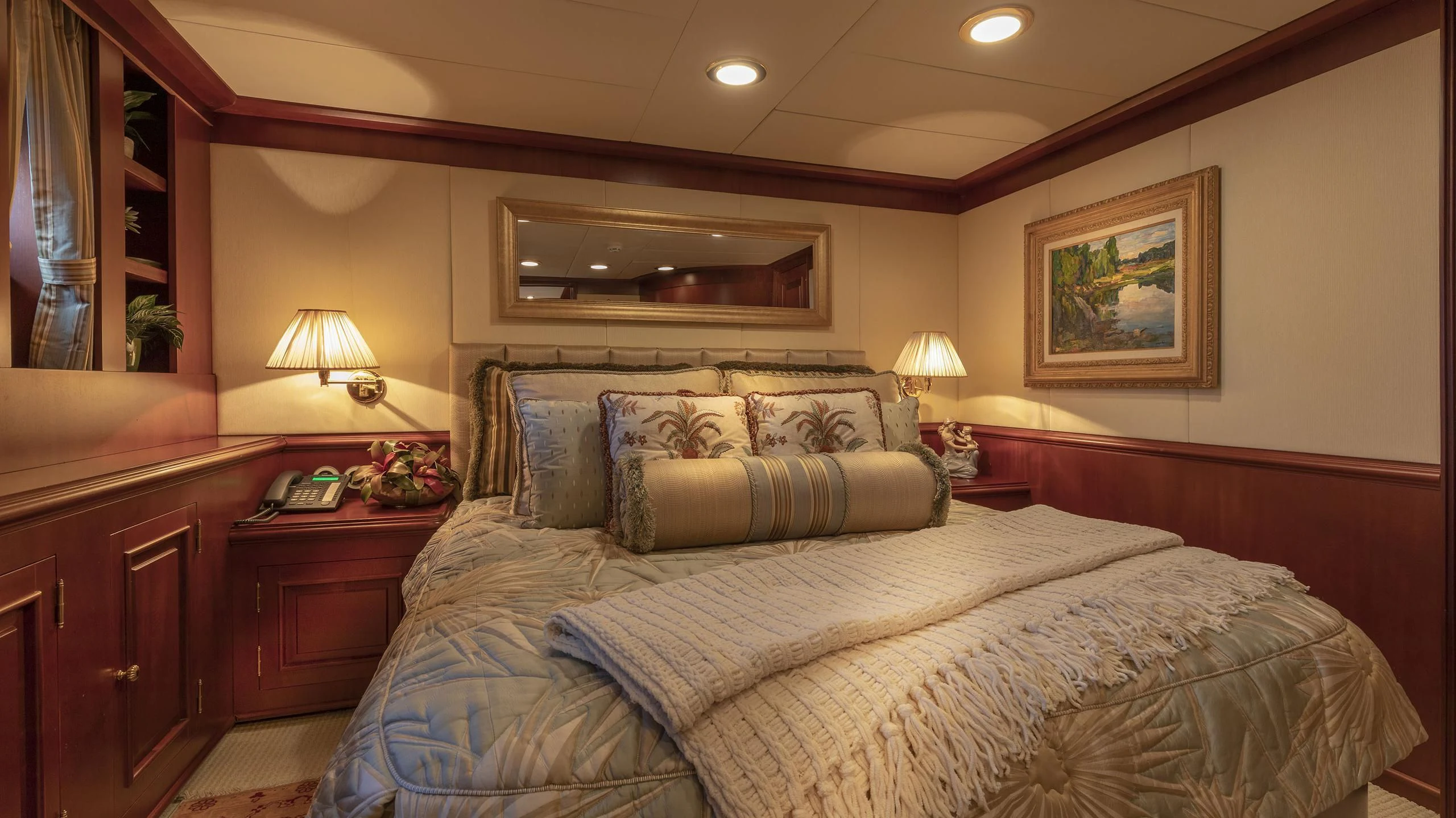 a bedroom with a bed and a lamp aboard MONTREVEL Yacht for Sale