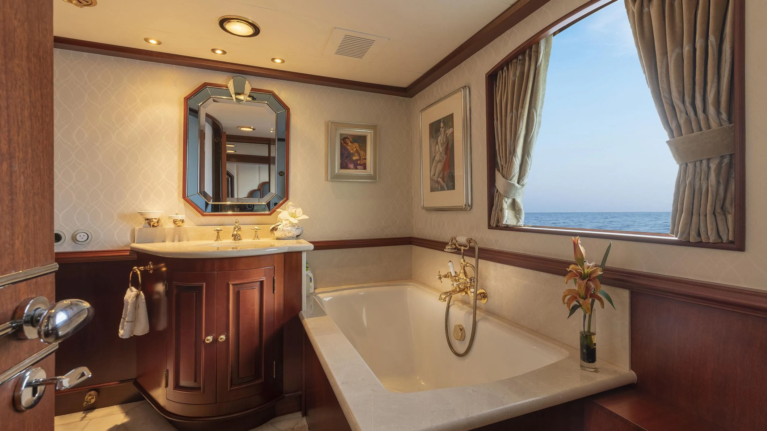 a bathroom with a bathtub and a sink aboard MONTREVEL Yacht for Sale