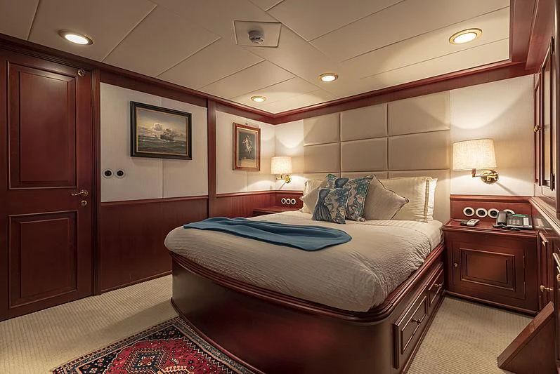 a bedroom with a bed and a desk aboard MONTREVEL Yacht for Sale