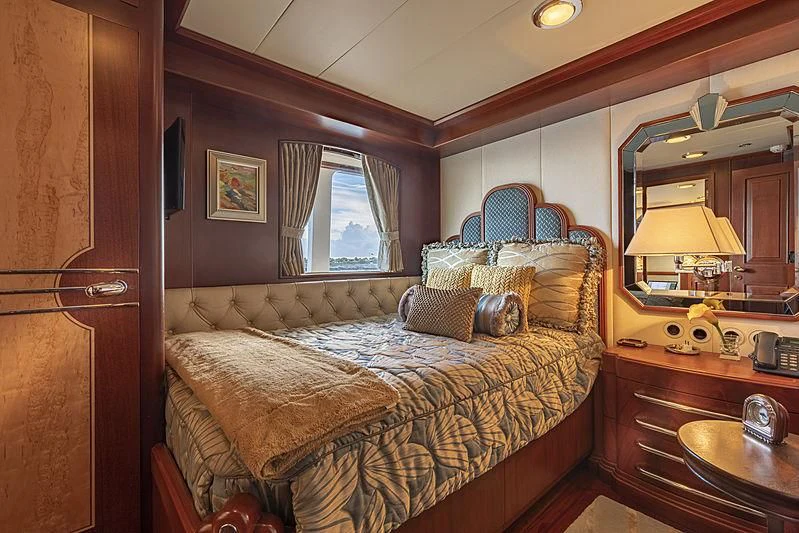 a bedroom with a bed and a mirror aboard MONTREVEL Yacht for Sale