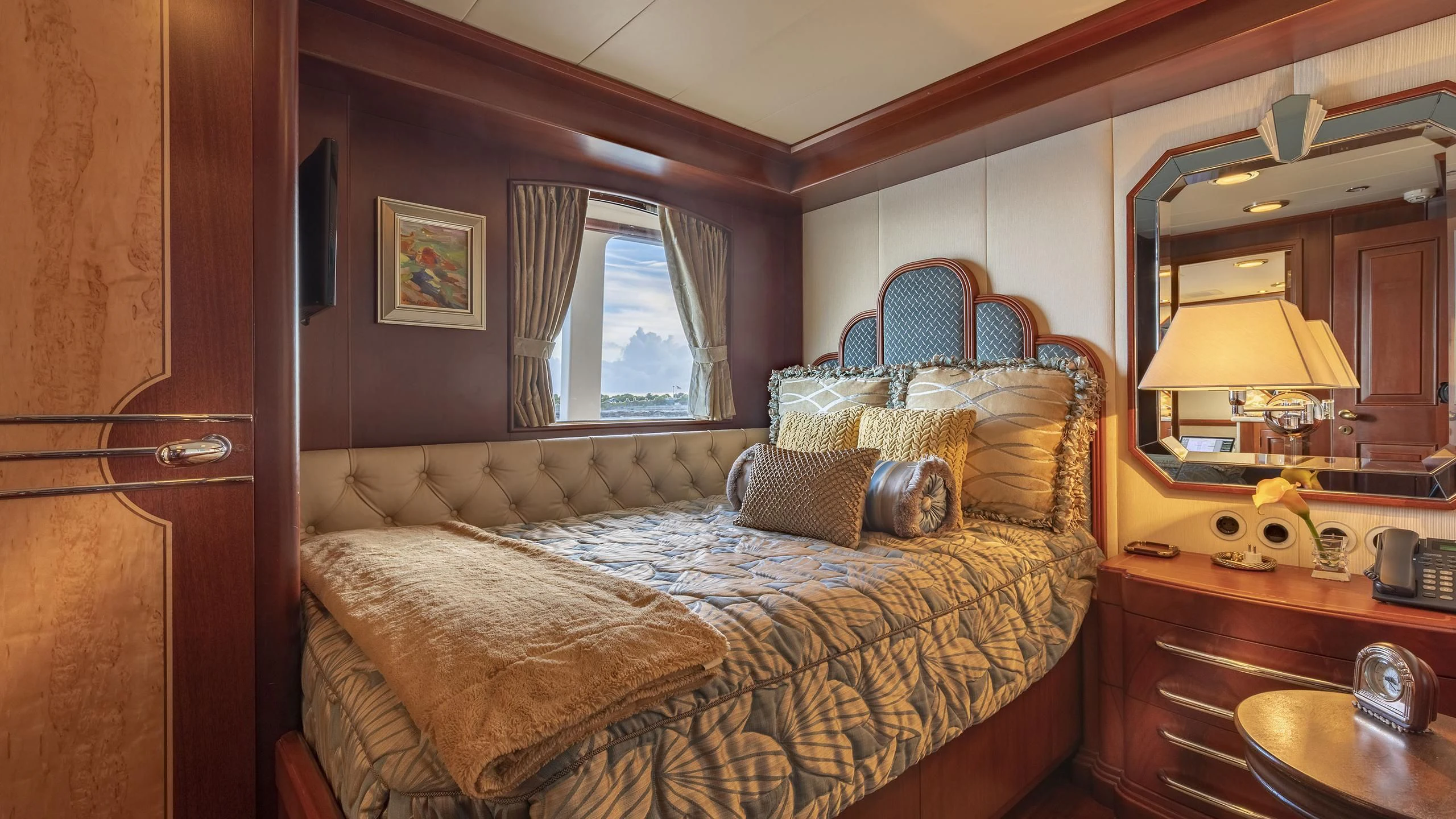 a bedroom with a bed and a desk aboard MONTREVEL Yacht for Sale