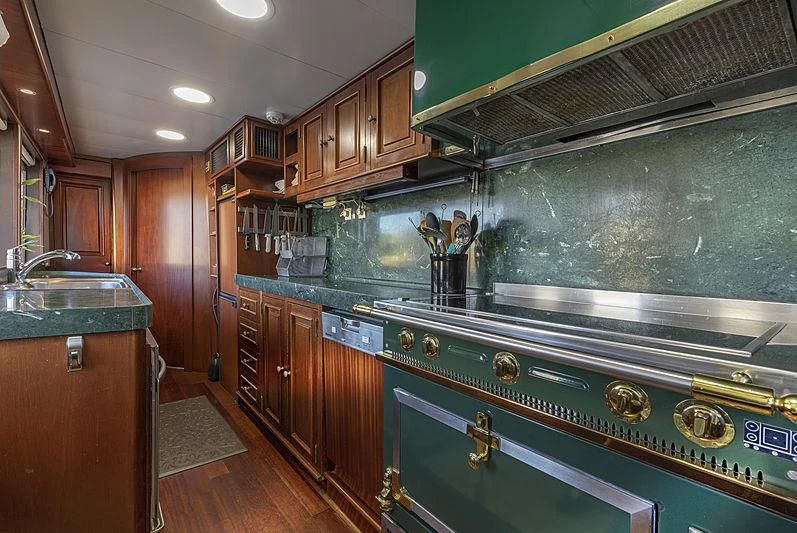 a kitchen with wooden cabinets aboard MONTREVEL Yacht for Sale