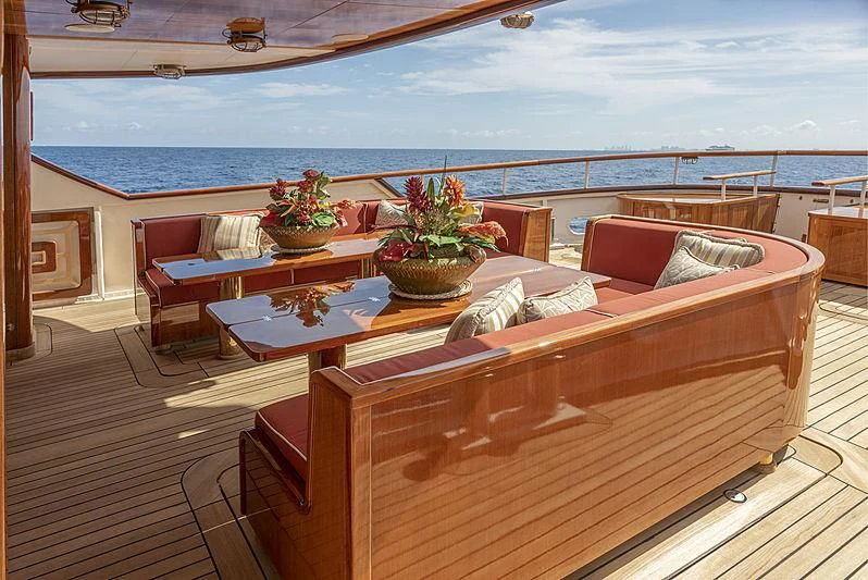 a room with a couch and a table with plants on it aboard MONTREVEL Yacht for Sale