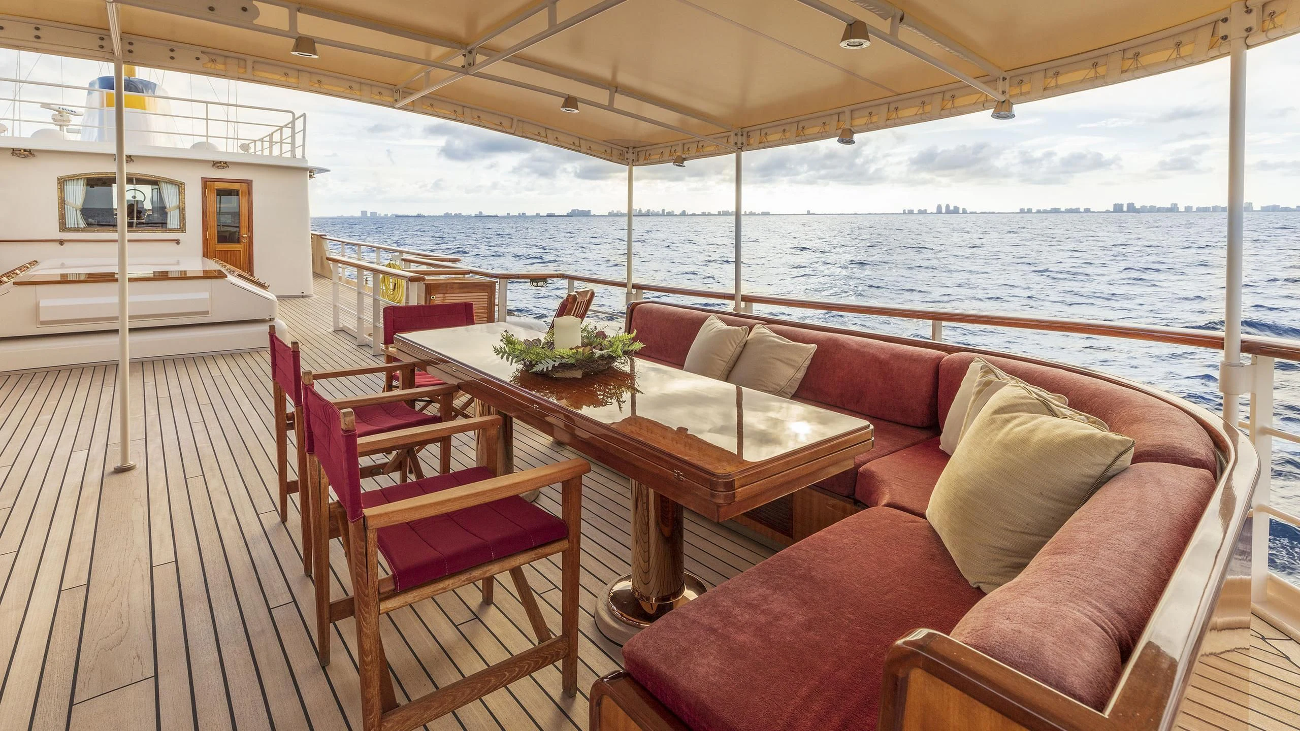 a deck with a couch and a table on it aboard MONTREVEL Yacht for Sale