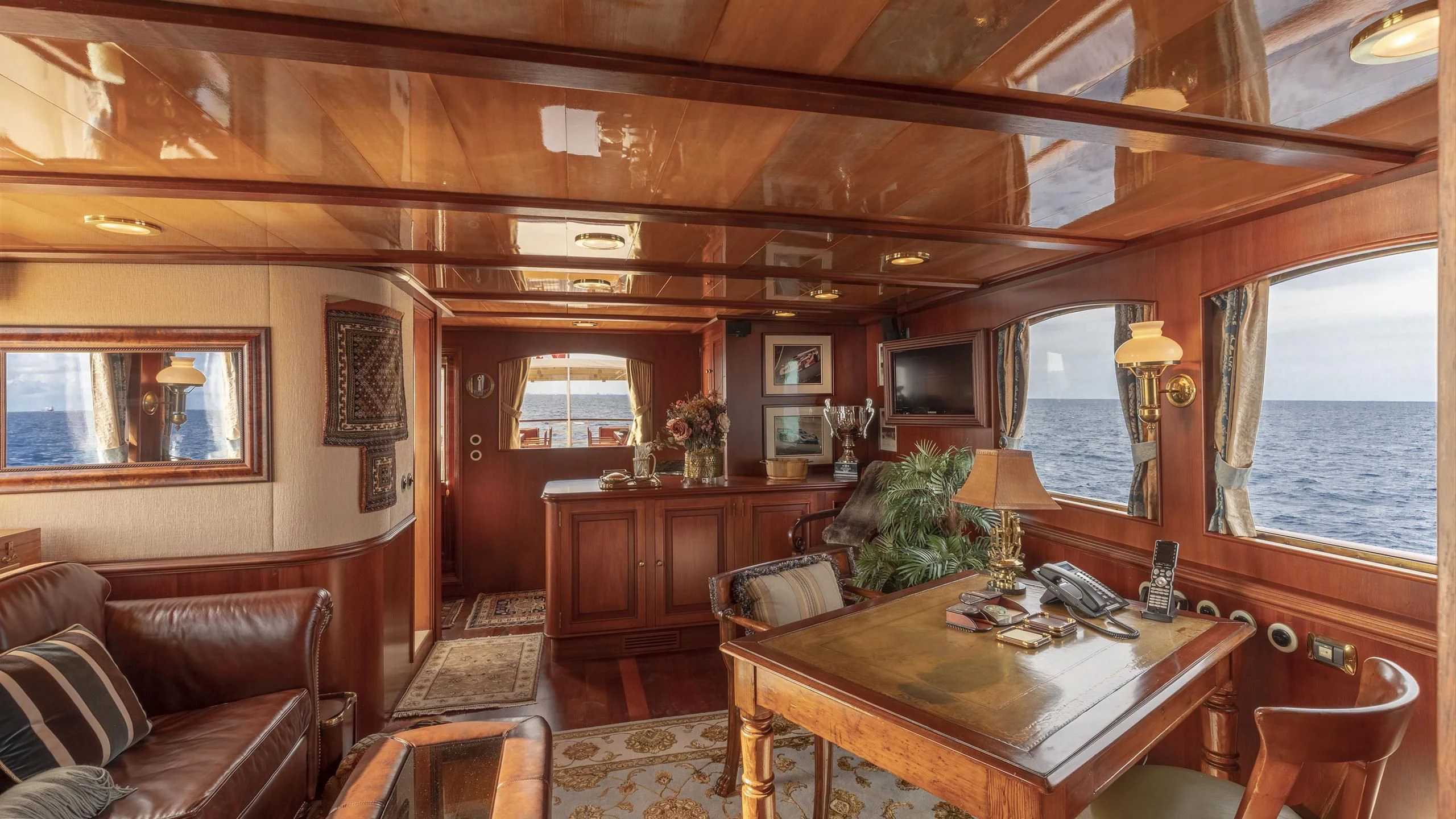 a living room with a couch and a table aboard MONTREVEL Yacht for Sale