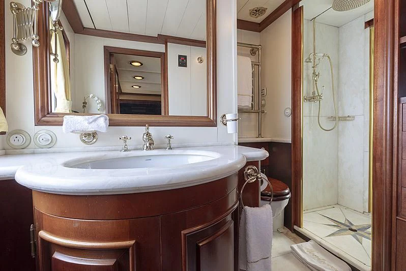 a bathroom with a sink and a mirror aboard MONTREVEL Yacht for Sale