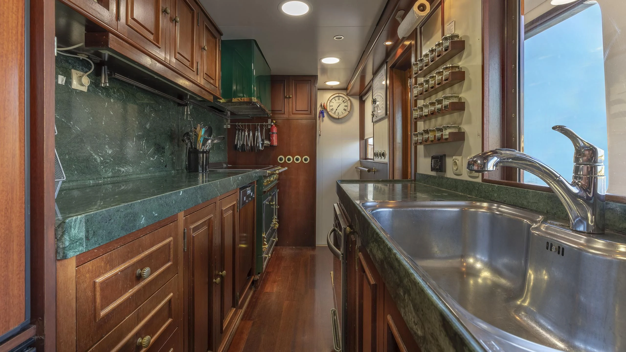 a kitchen with a stainless steel sink aboard MONTREVEL Yacht for Sale