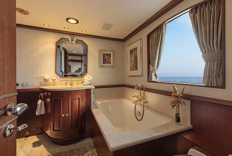 a bathroom with a bathtub and sink aboard MONTREVEL Yacht for Sale