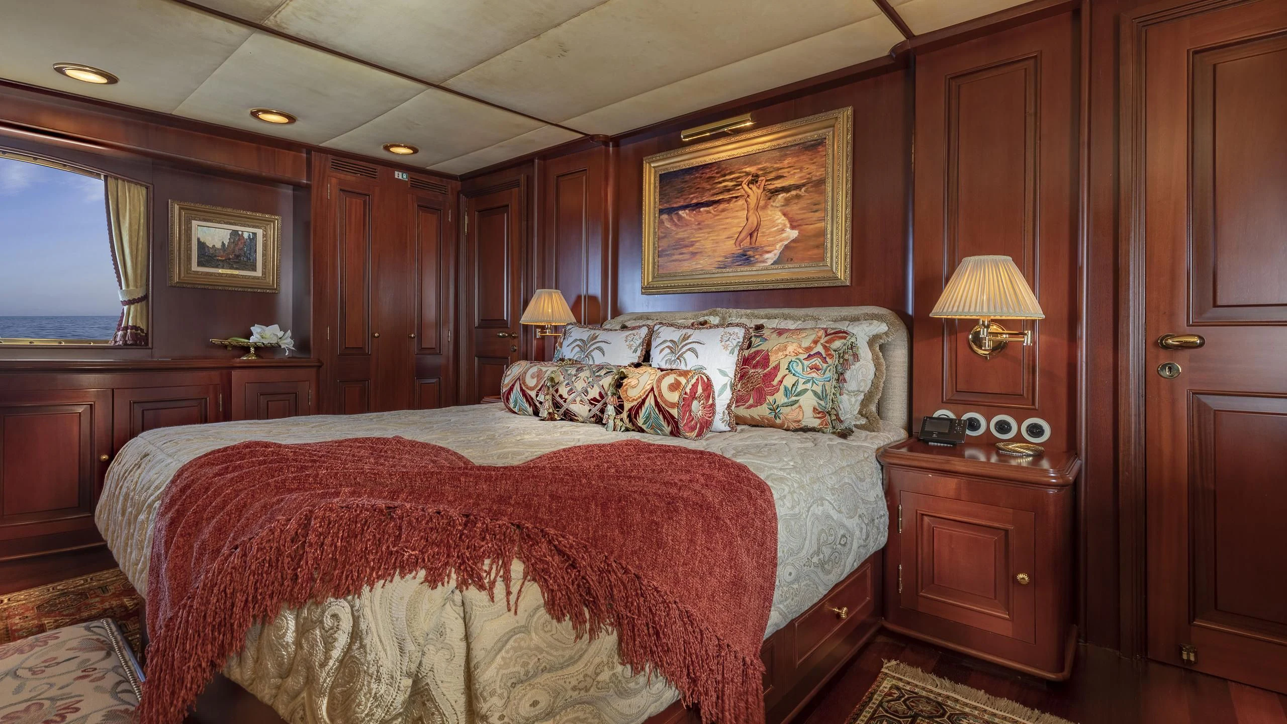 a bedroom with a bed and a lamp aboard MONTREVEL Yacht for Sale