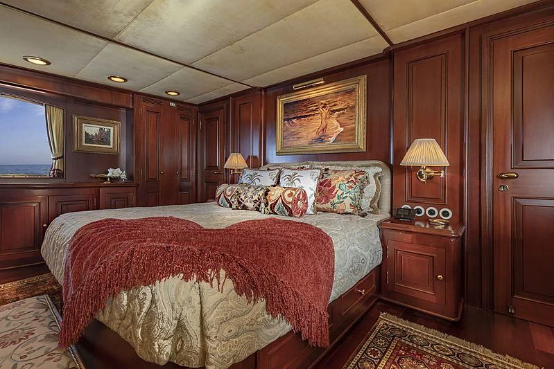 a bedroom with a bed and a desk aboard MONTREVEL Yacht for Sale
