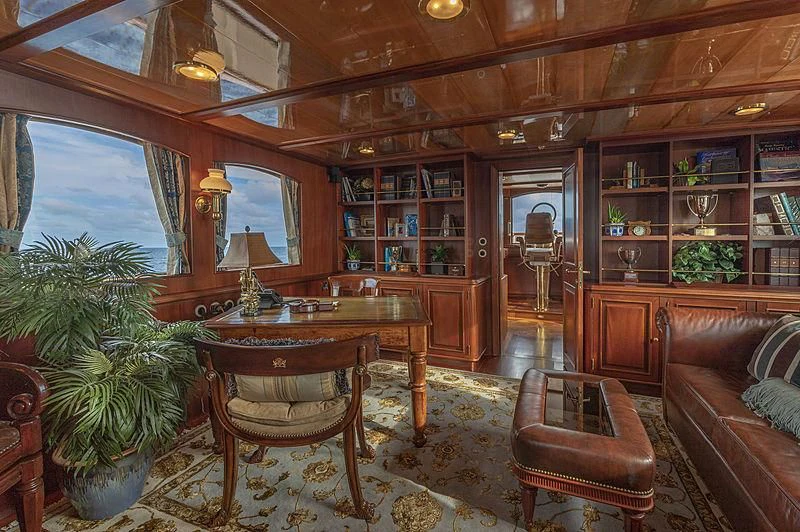 a living room with a table and chairs aboard MONTREVEL Yacht for Sale