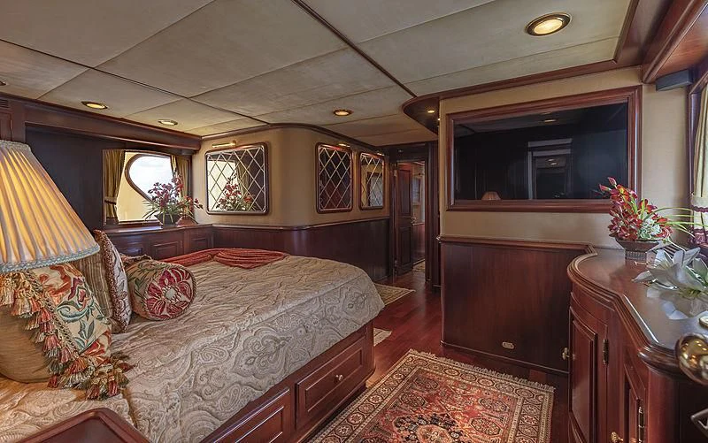 a bedroom with a bed and a desk aboard MONTREVEL Yacht for Sale