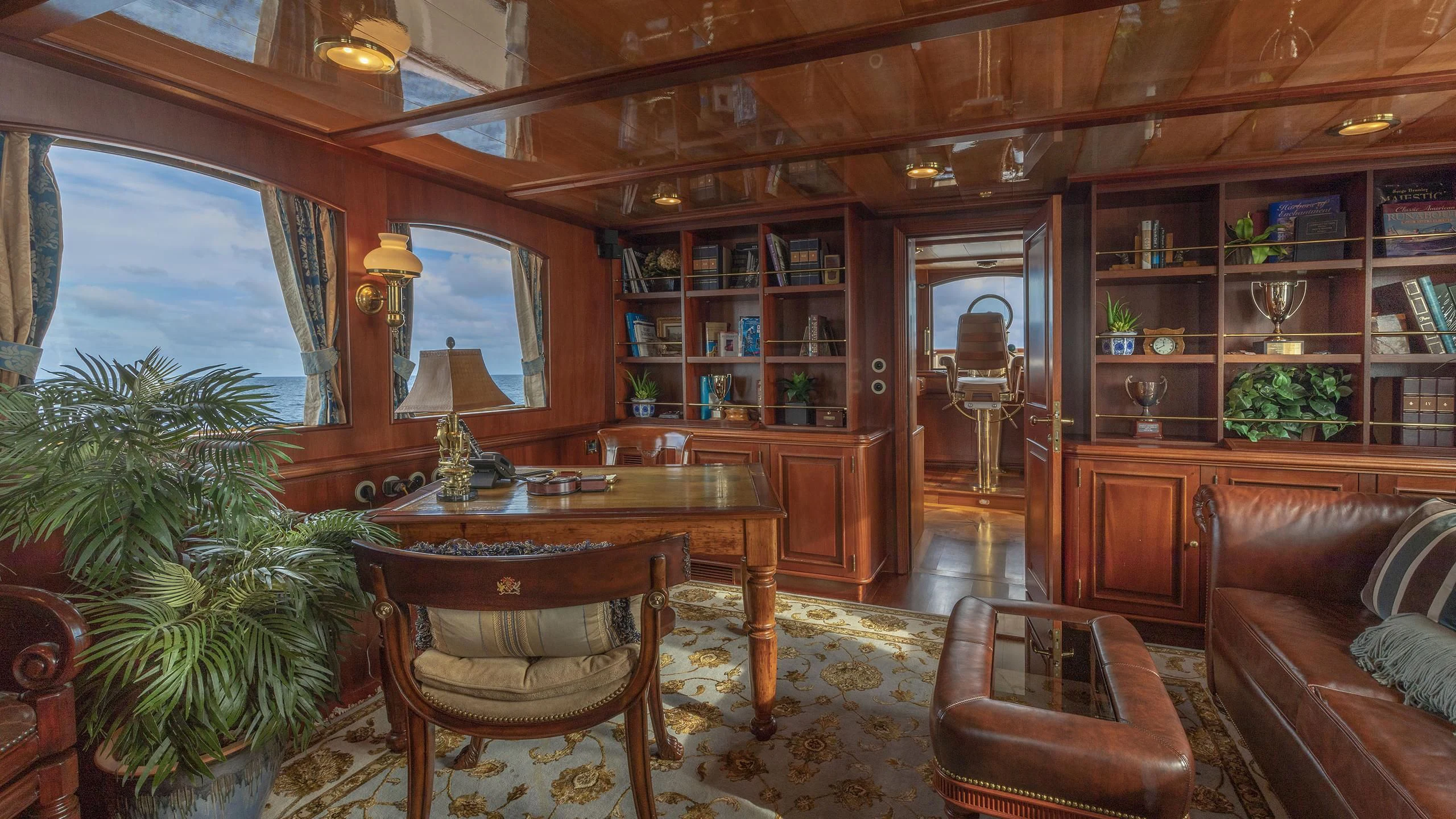 a living room with a table and chairs aboard MONTREVEL Yacht for Sale