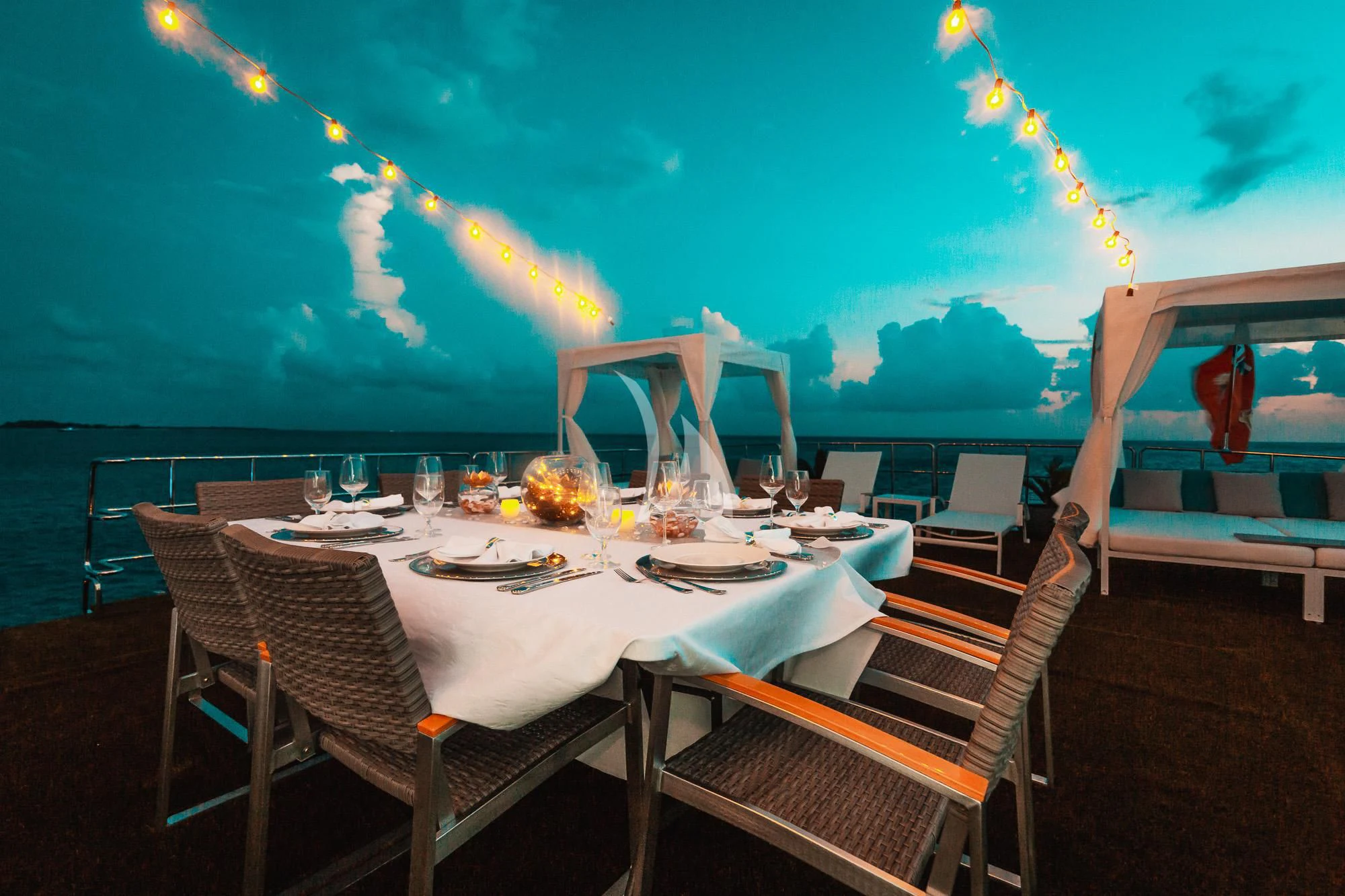 a table set for a dinner party aboard SAMARA Yacht for Charter