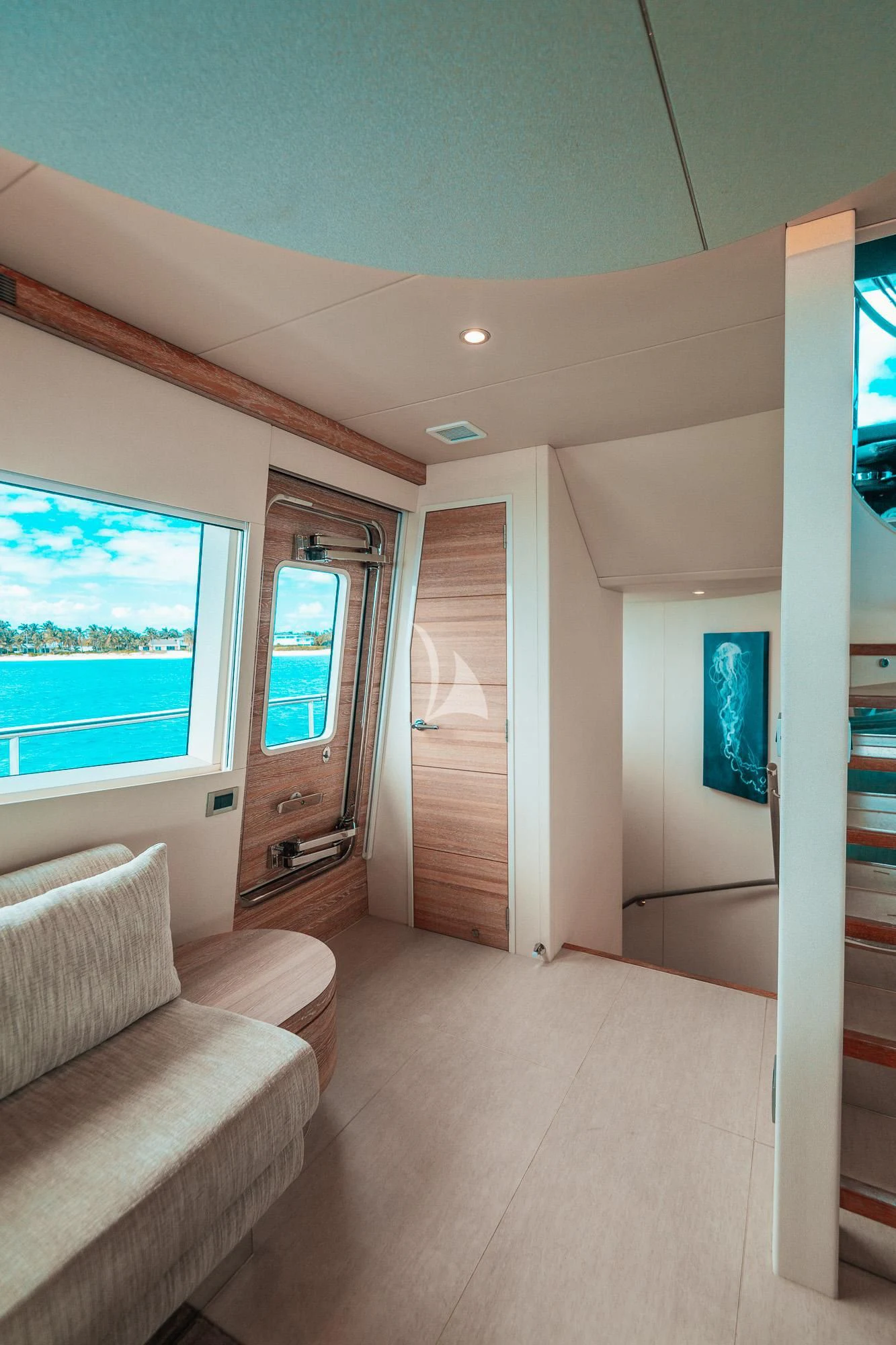 a living room with a couch and a window aboard SAMARA Yacht for Charter