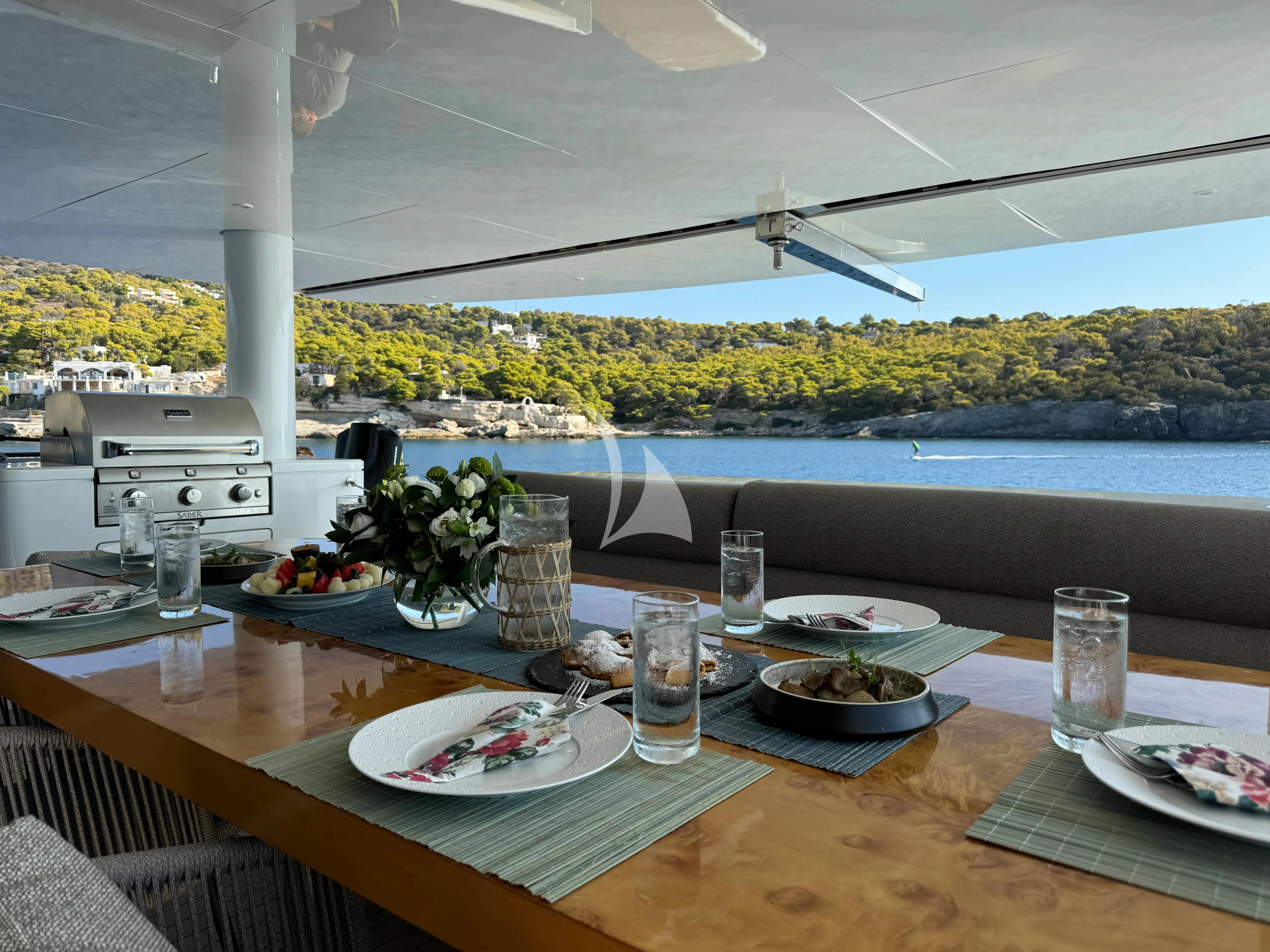 a table with plates and food on it aboard SAMARA Yacht for Charter