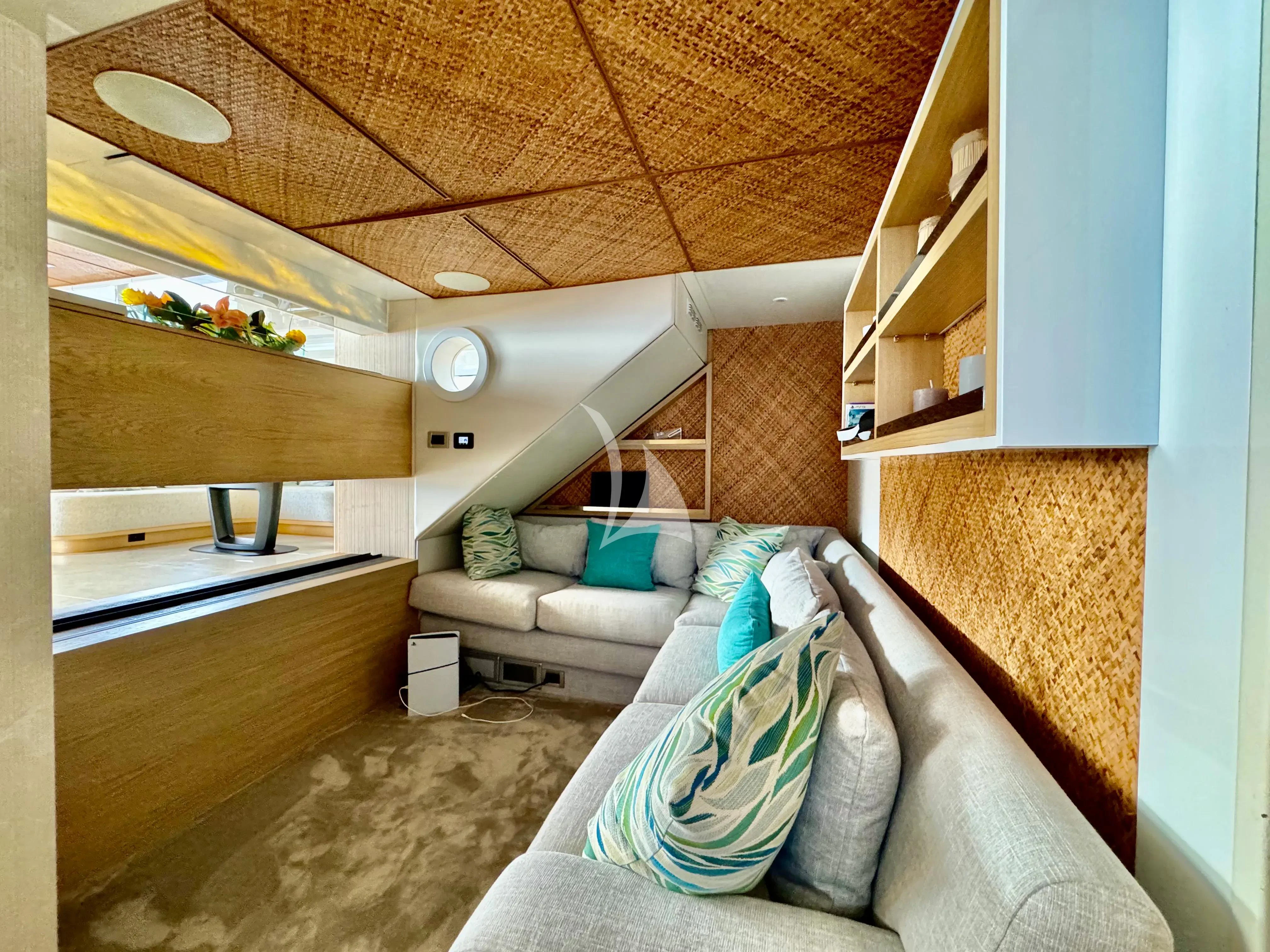 a living room with a couch and a staircase aboard SAMARA Yacht for Charter