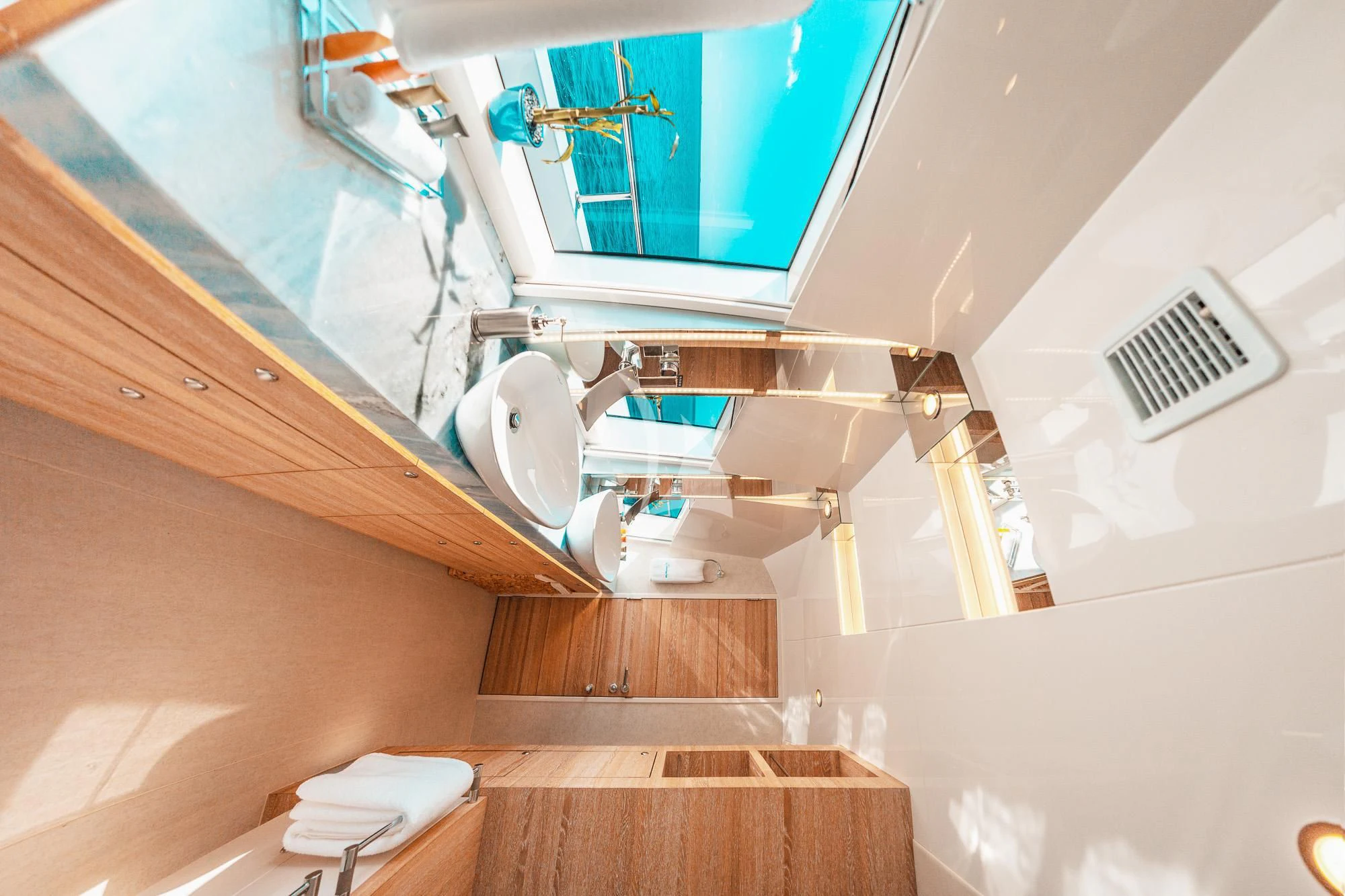 a bathroom with a tub sink and cabinets aboard SAMARA Yacht for Charter