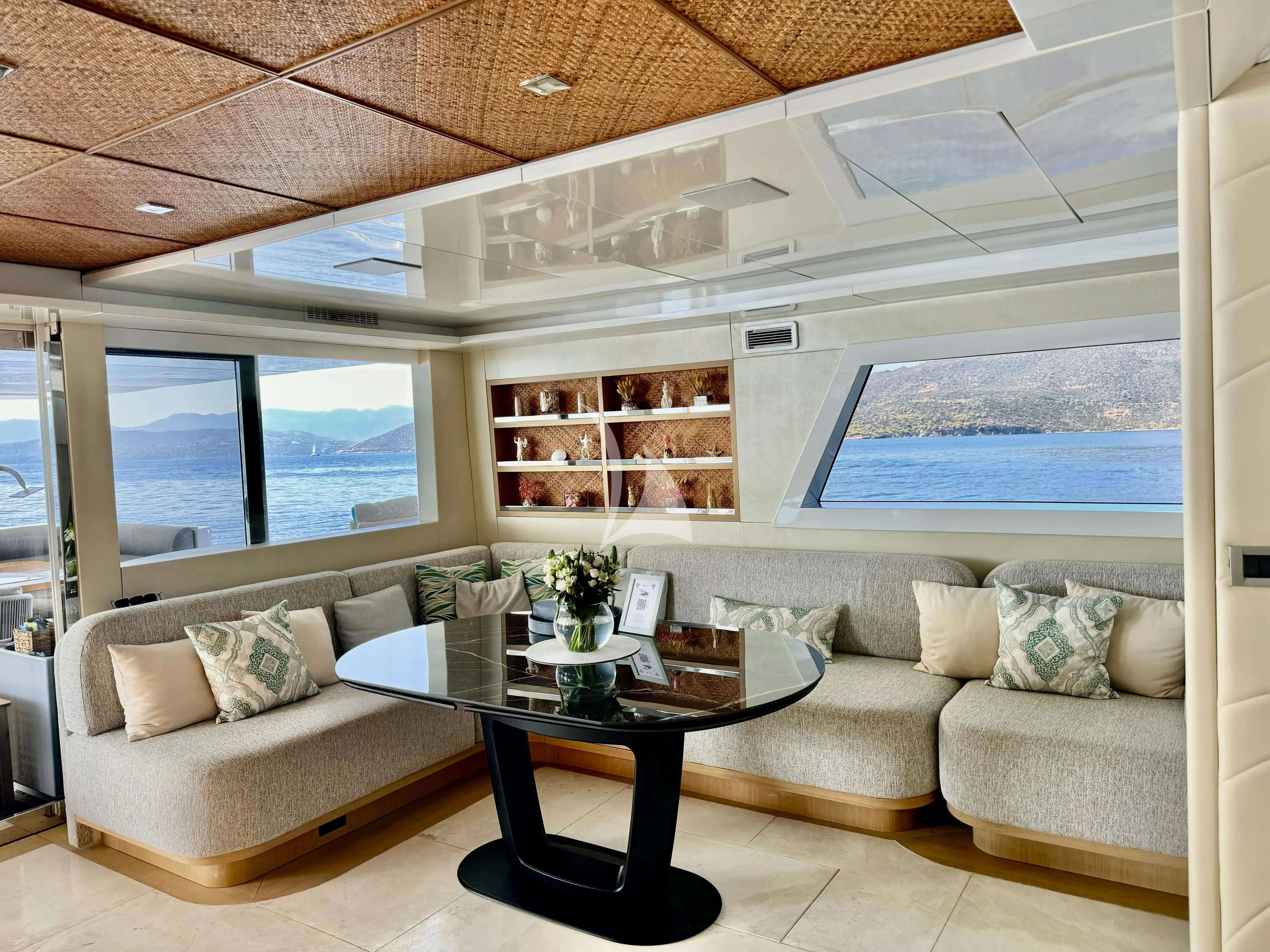 a living room with a large window aboard SAMARA Yacht for Charter