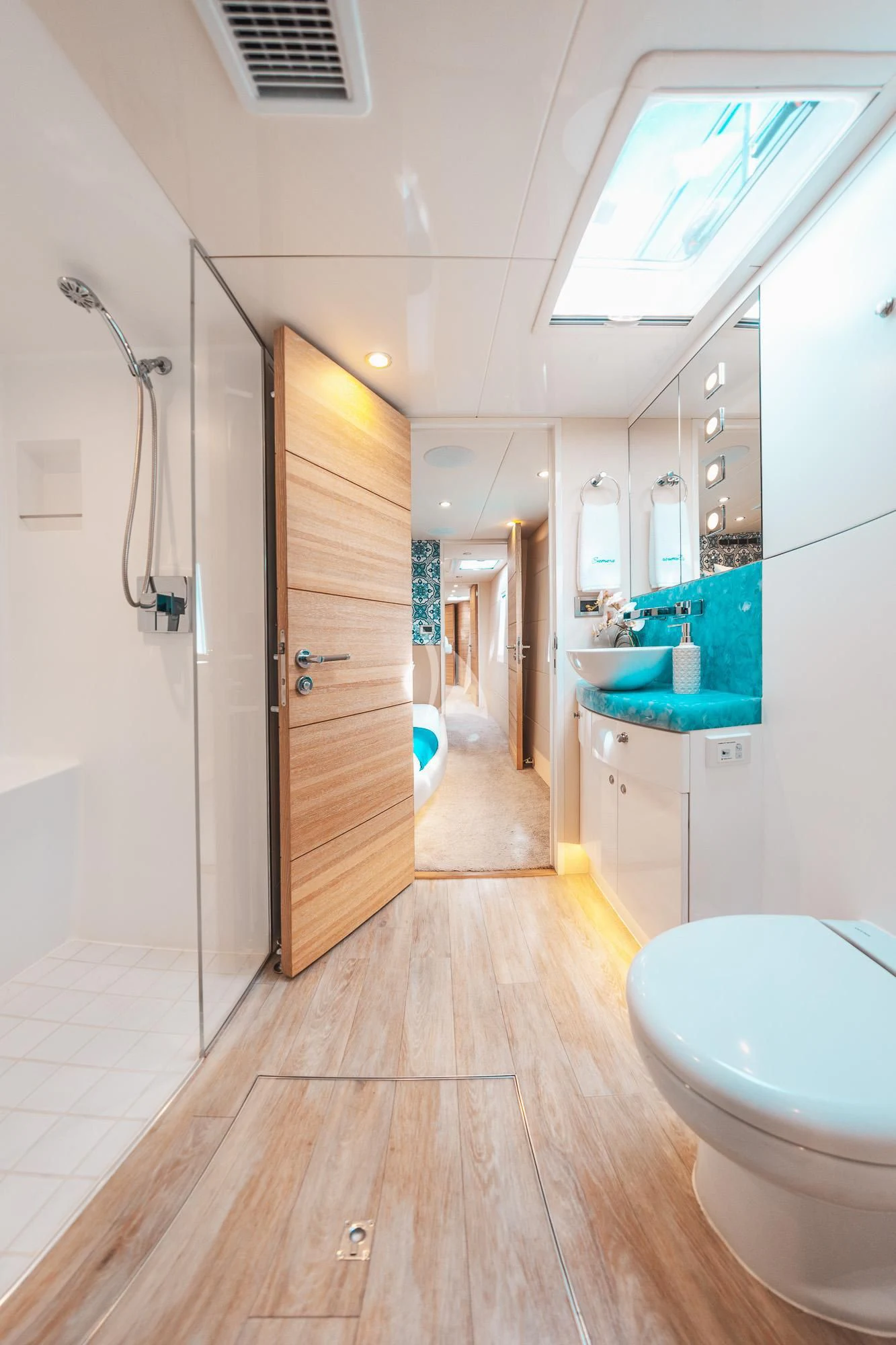 a bathroom with a wood floor aboard SAMARA Yacht for Charter