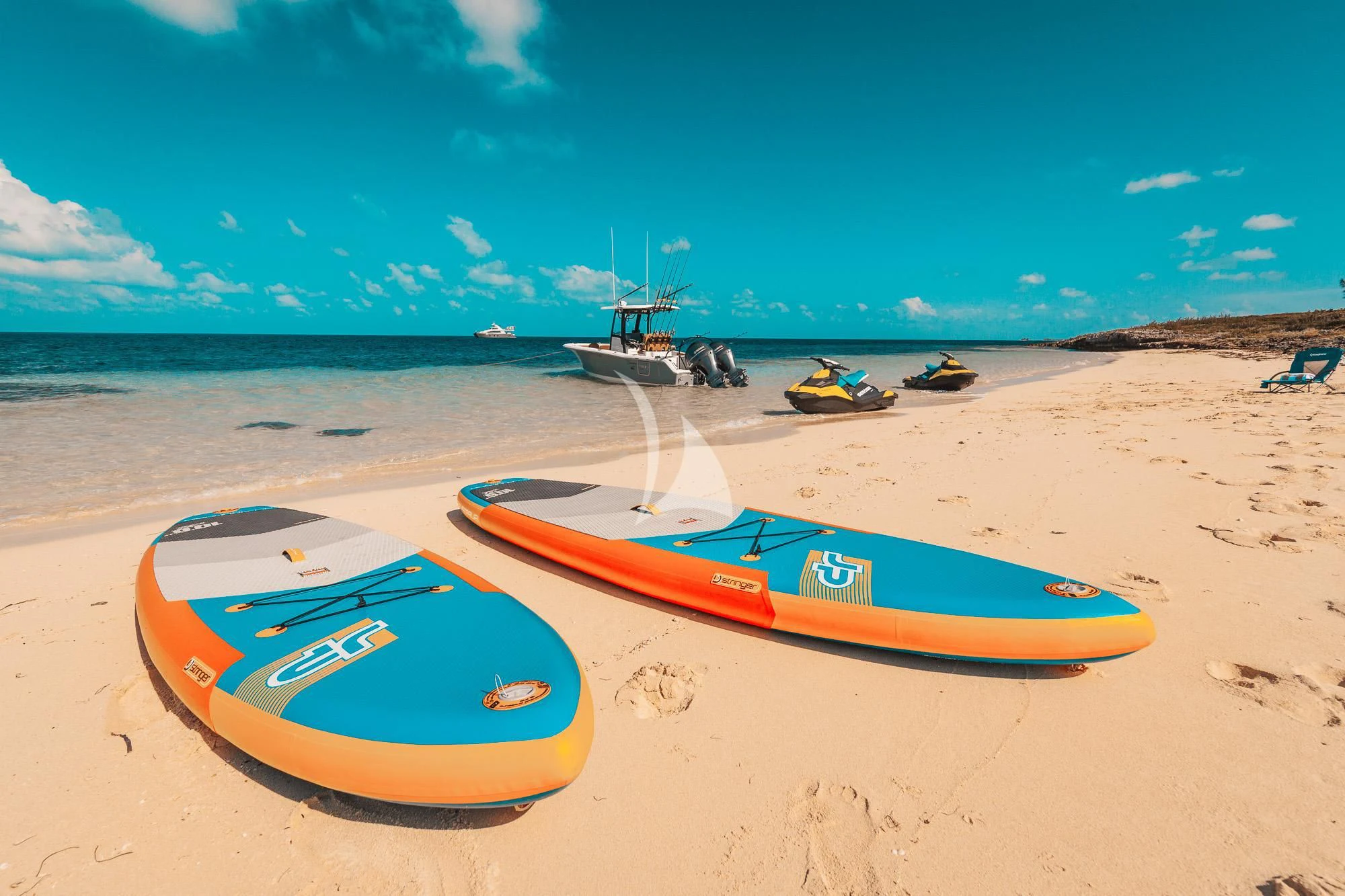 surfboards on a beach aboard SAMARA Yacht for Charter