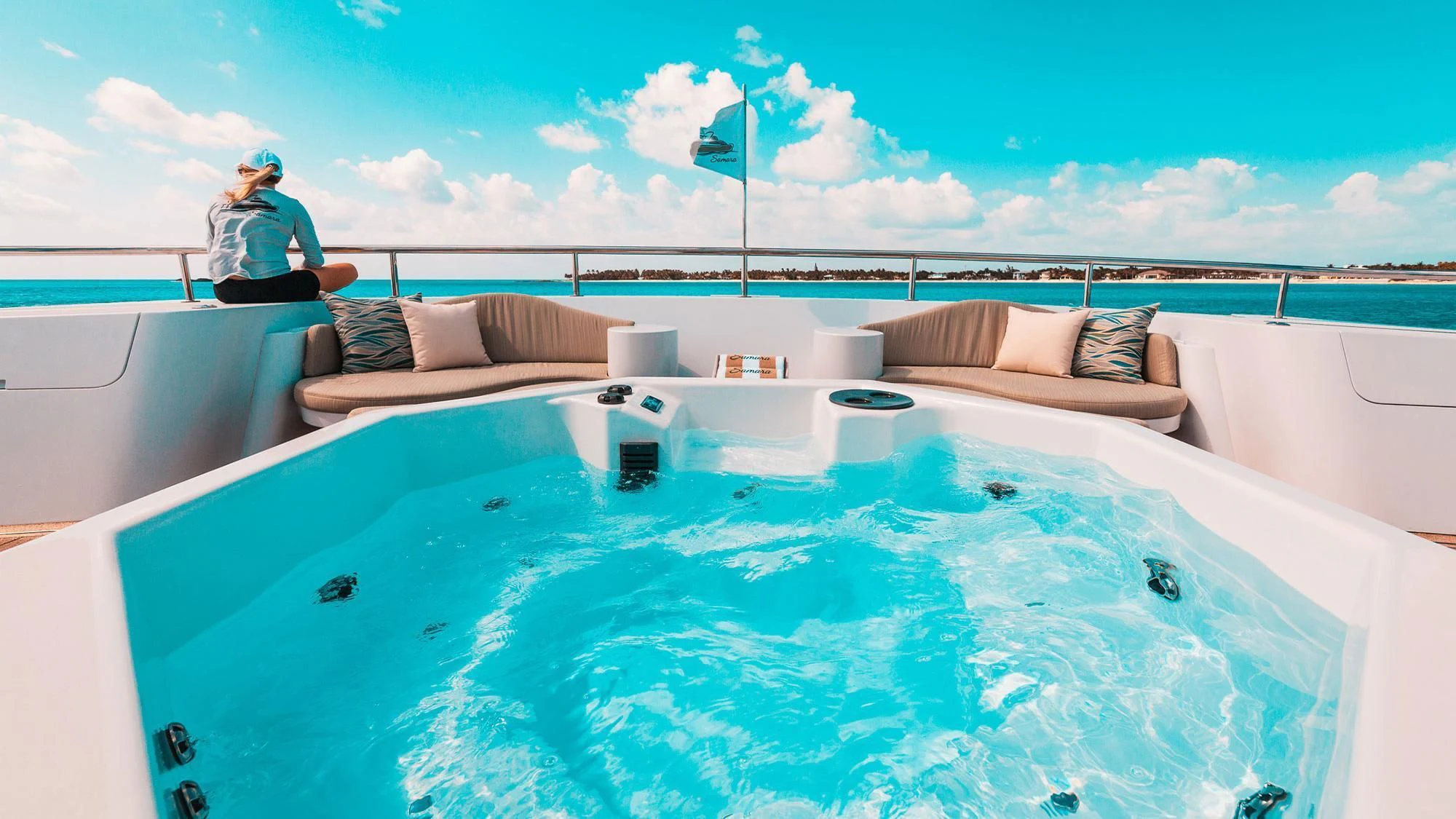 a person sitting on a lounge chair in a pool aboard SAMARA Yacht for Charter