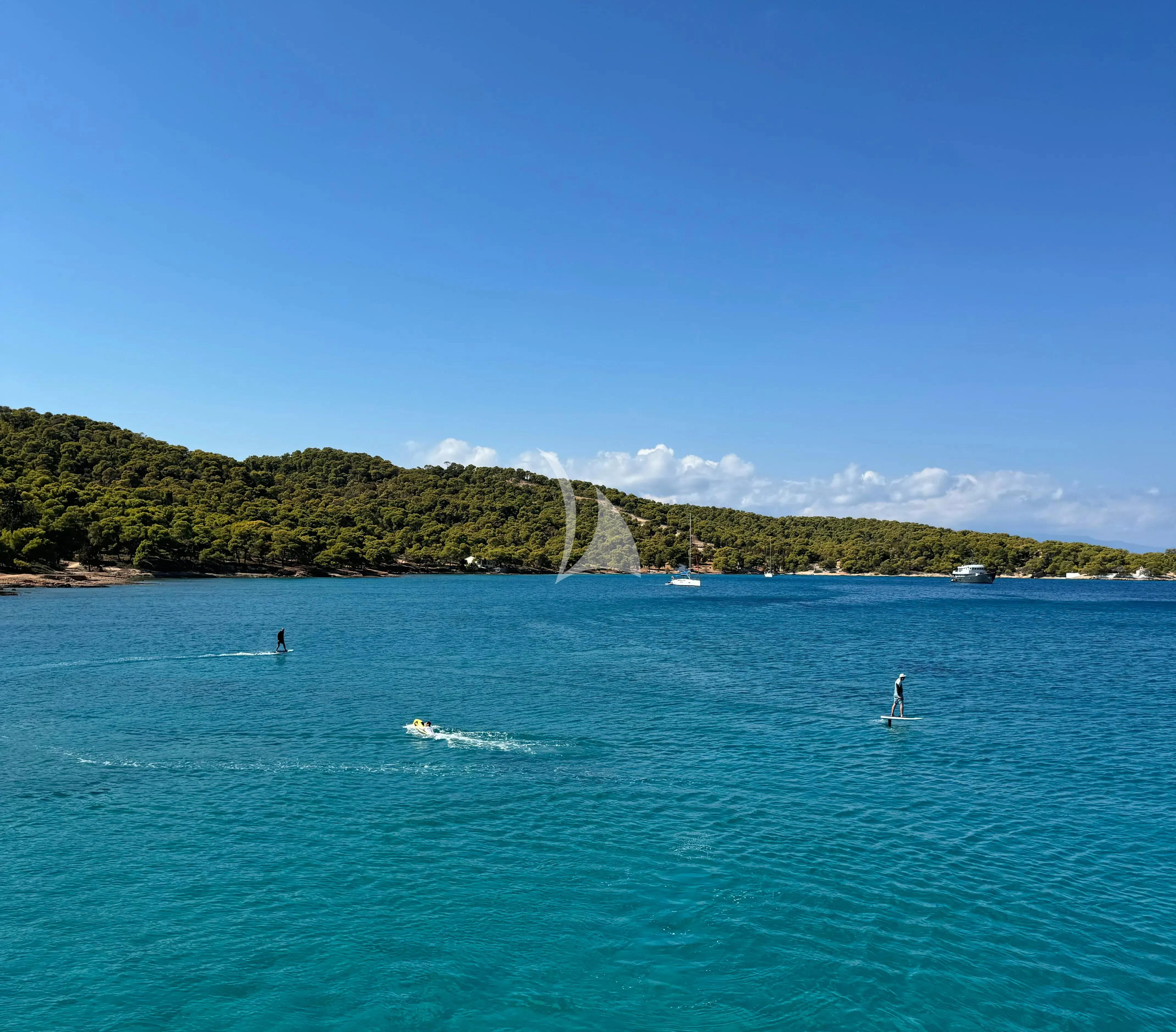 a body of water with a mountain in the background aboard SAMARA Yacht for Charter