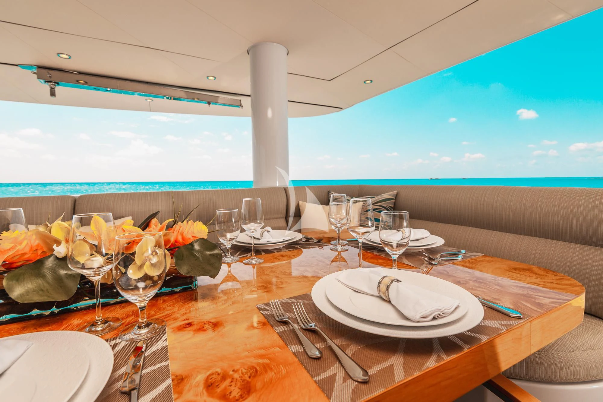a table set with plates and glasses aboard SAMARA Yacht for Charter