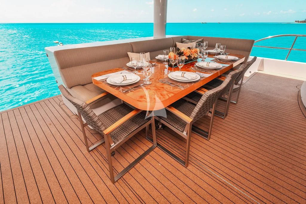 a table set on a deck overlooking the ocean aboard SAMARA Yacht for Charter