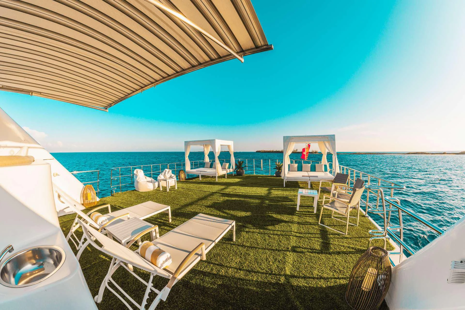 a deck with chairs and a table on it by the water aboard SAMARA Yacht for Charter
