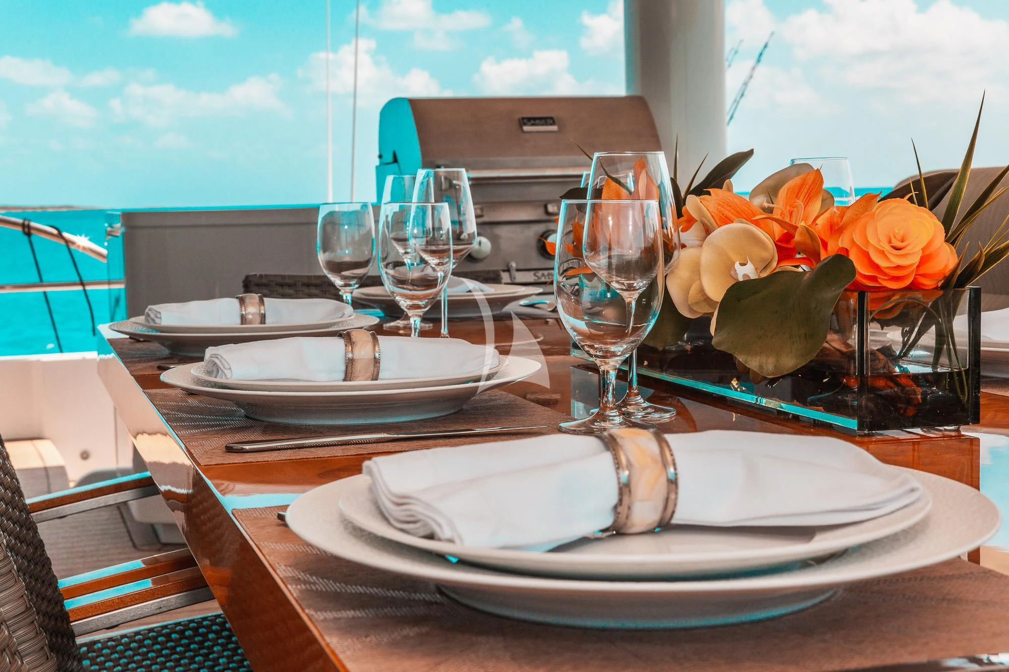 a table with plates and glasses on it aboard SAMARA Yacht for Charter