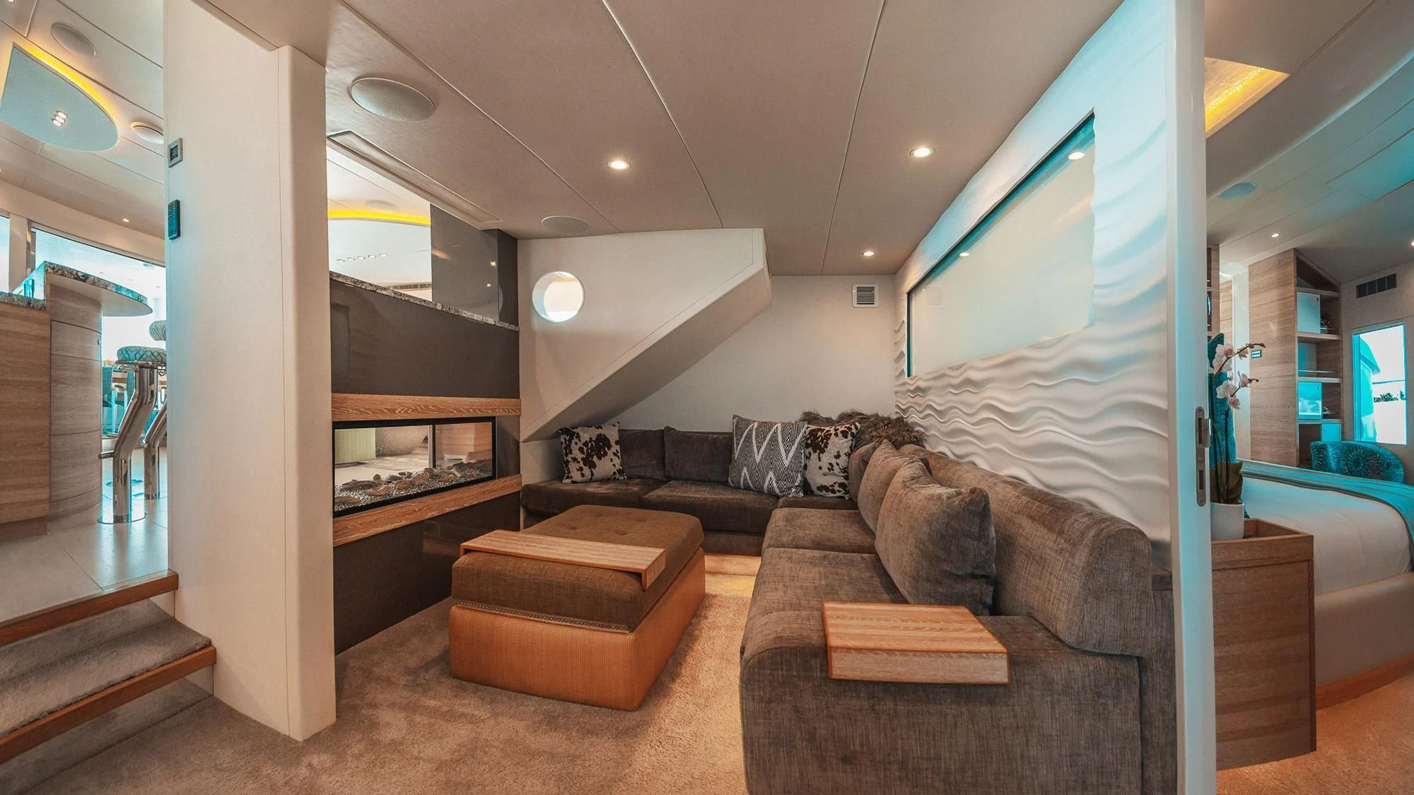 a living room with a couch and a large window aboard SAMARA Yacht for Charter