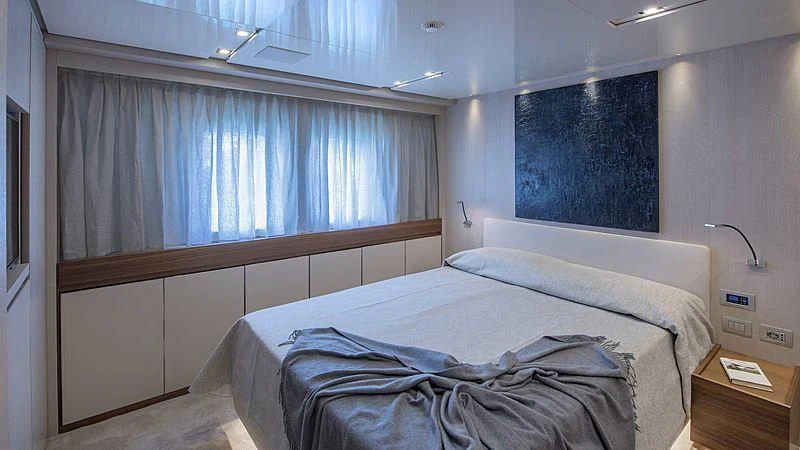 a room with a bed and a window aboard OCTAVE Yacht for Sale
