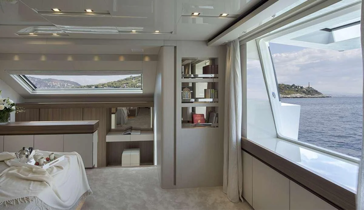 a room with a bed and a window aboard OCTAVE Yacht for Sale