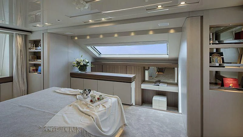 a room with a bed and a desk aboard OCTAVE Yacht for Sale