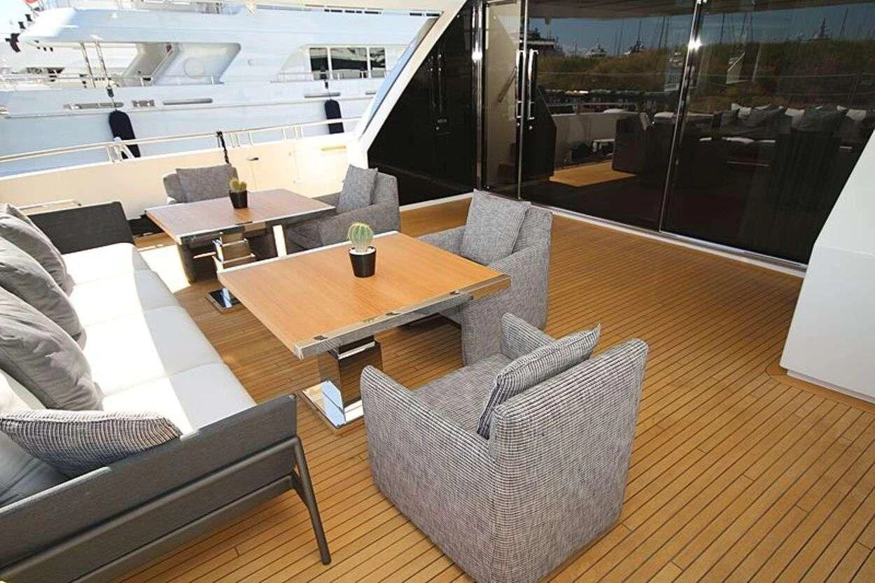 a room with a table and chairs aboard OCTAVE Yacht for Sale