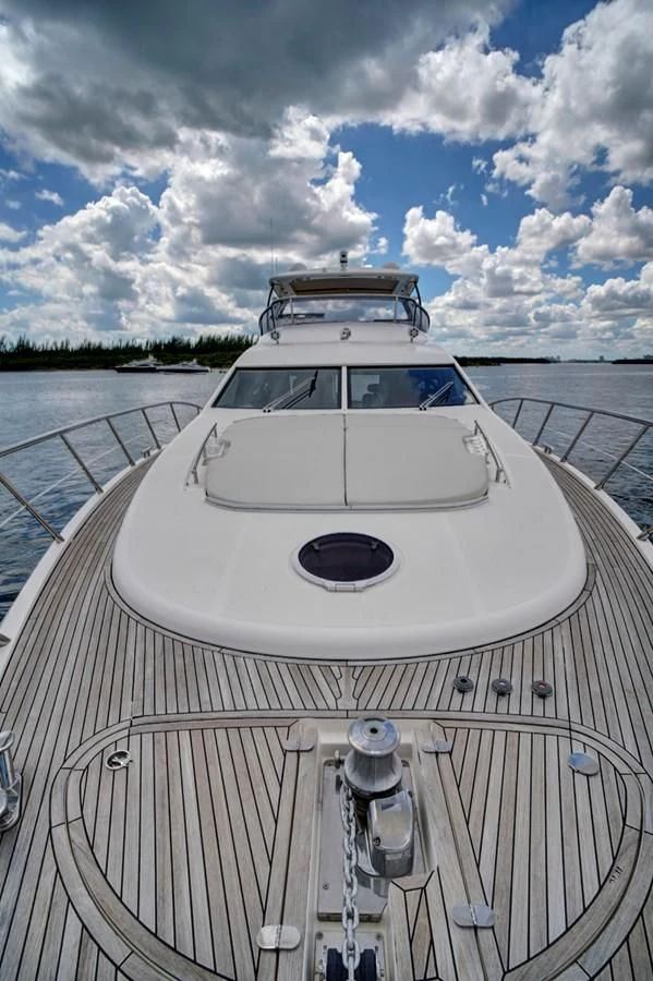 a white boat on a dock aboard WICKED Yacht for Sale