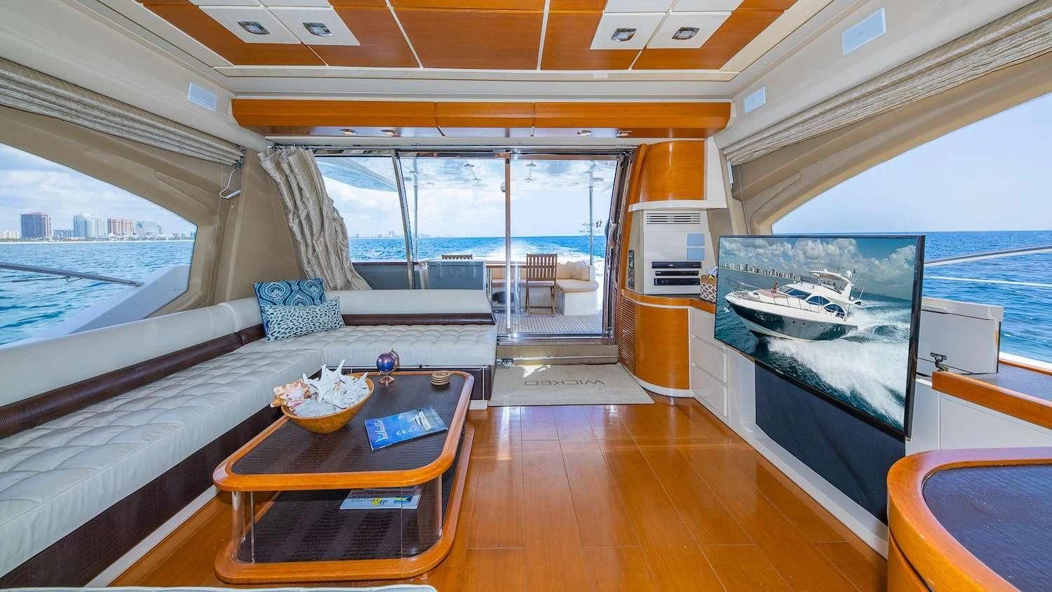 a room with a table and a bed aboard WICKED Yacht for Sale