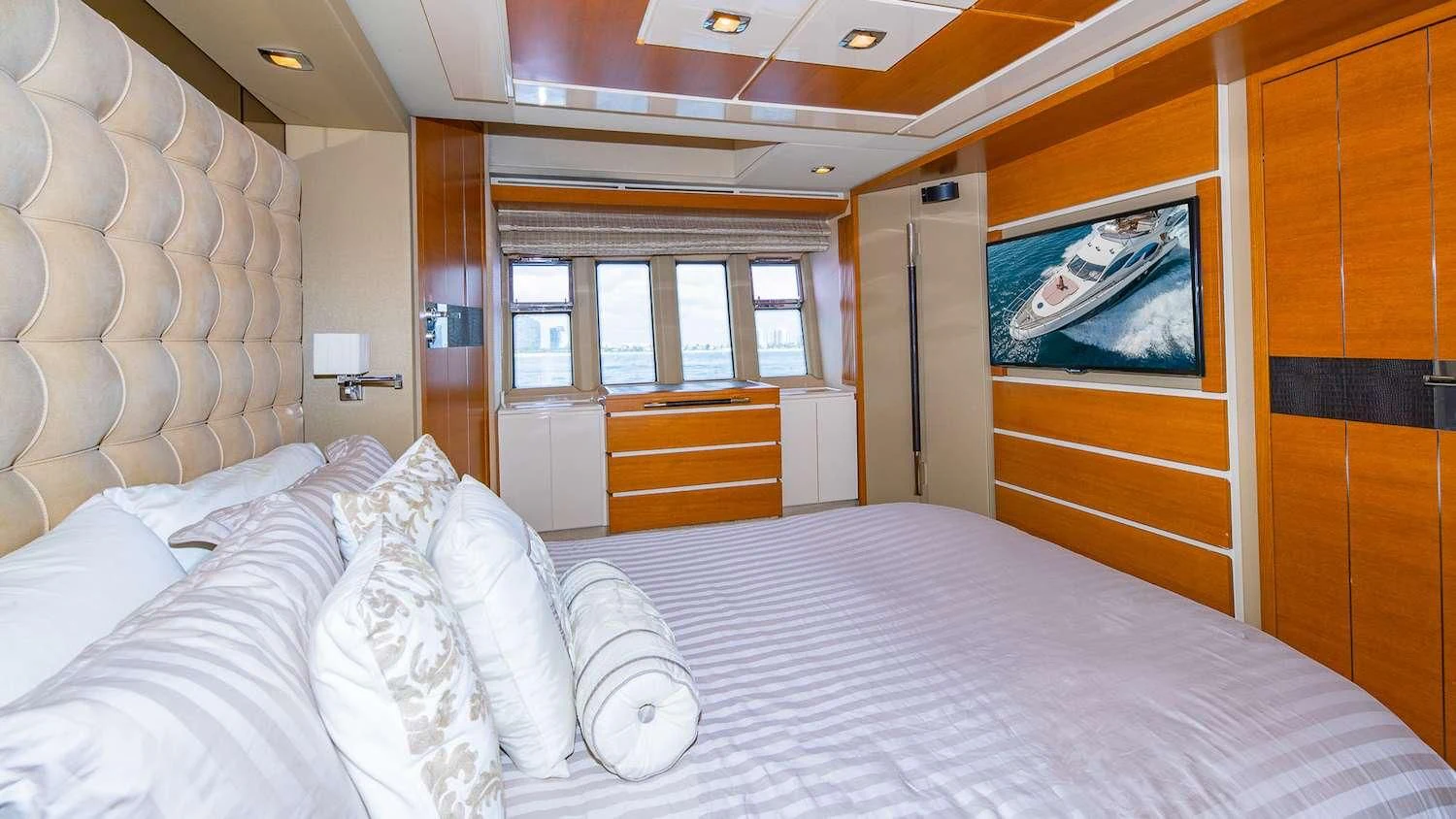 a bed with white sheets aboard WICKED Yacht for Sale