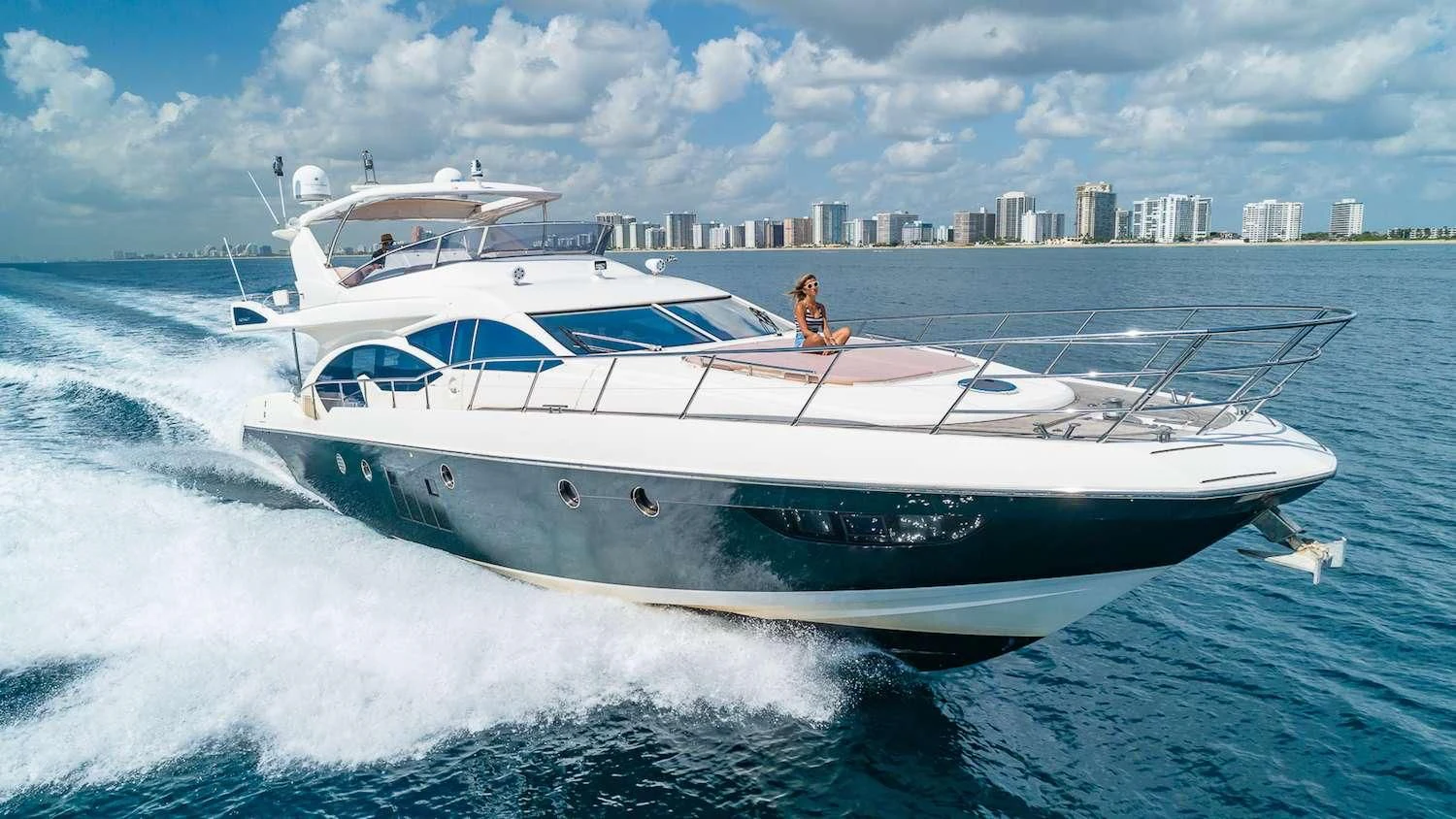a white yacht with a person on it aboard WICKED Yacht for Sale