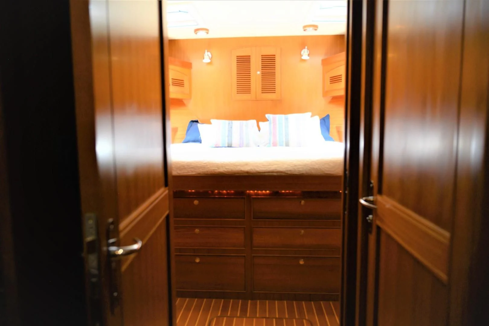 a room with a bed and a closet aboard VK Yacht for Sale