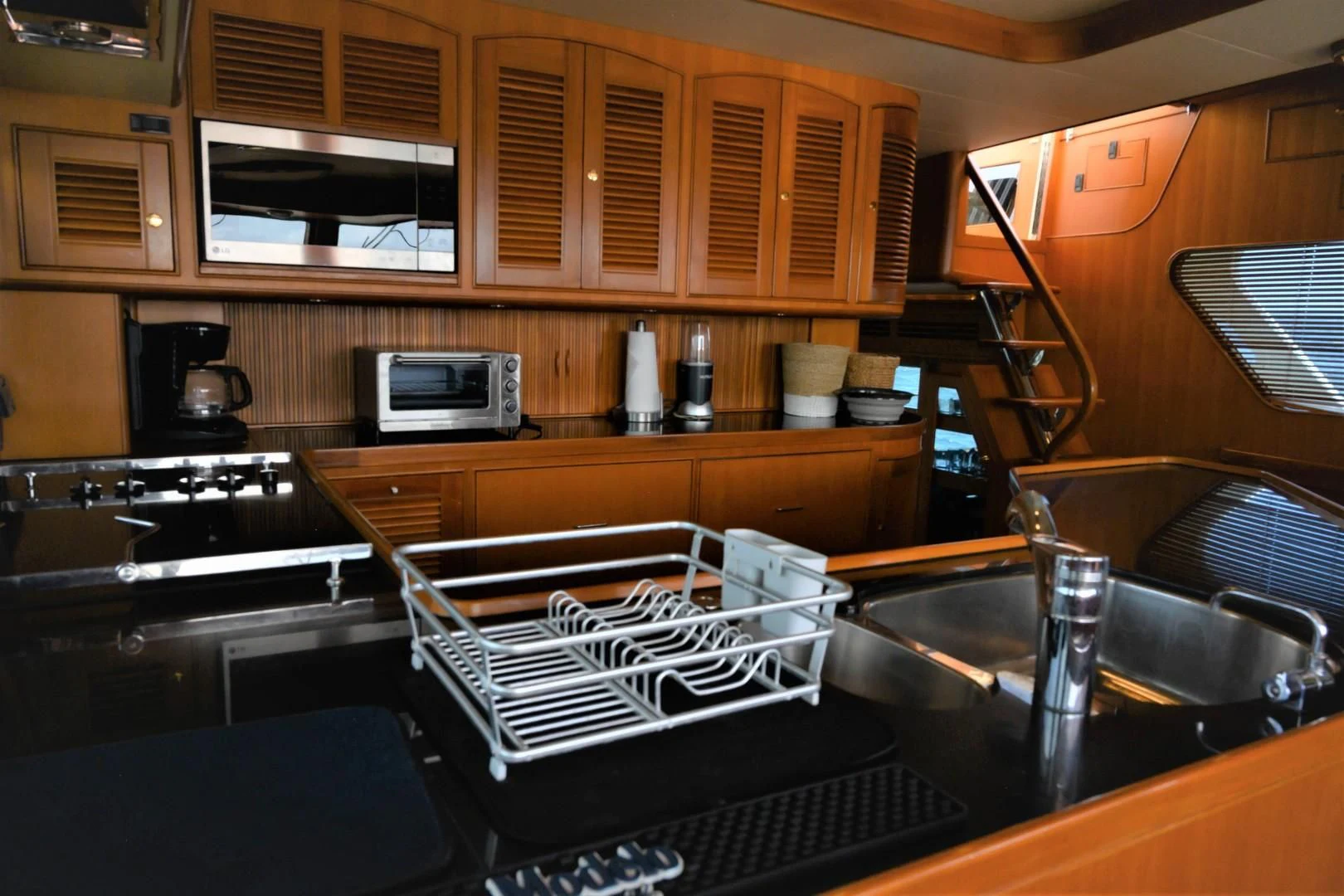 a kitchen with wooden cabinets aboard VK Yacht for Sale