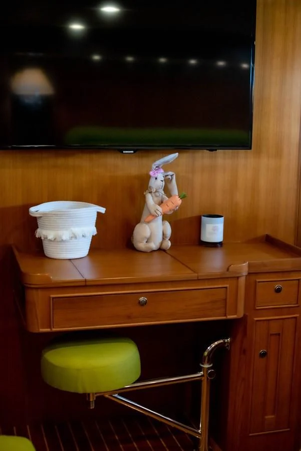 a wooden shelf with a white toy figurine on it aboard VK Yacht for Sale