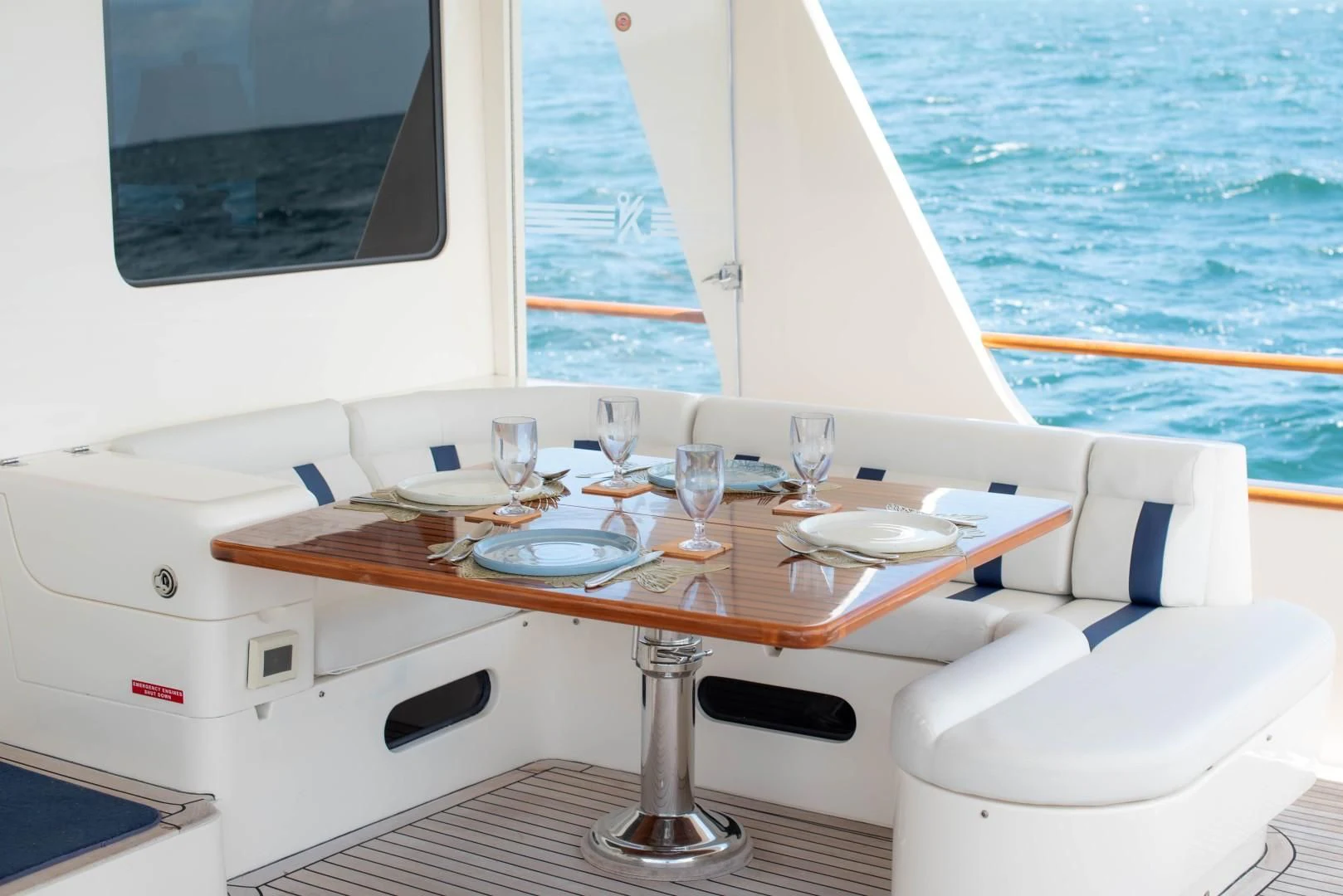 a table with plates and glasses on it aboard VK Yacht for Sale