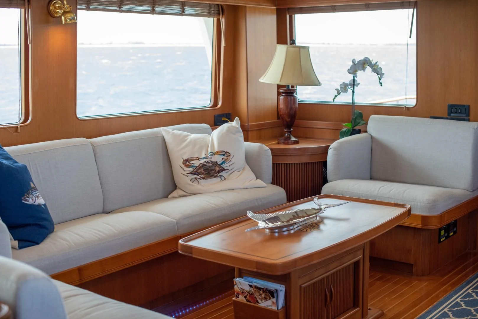 a living room with a coffee table and couches aboard VK Yacht for Sale