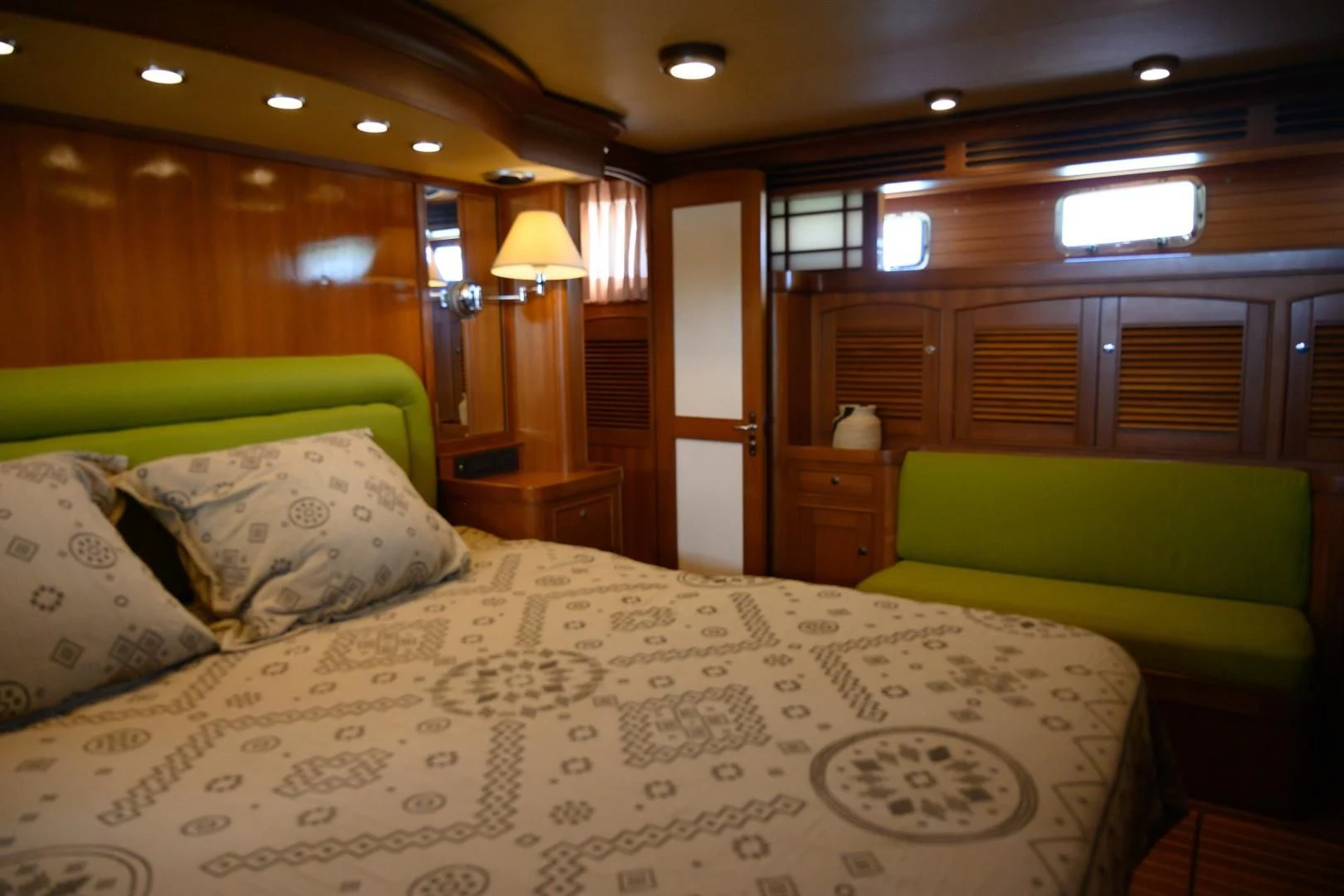a bed with a white comforter aboard VK Yacht for Sale