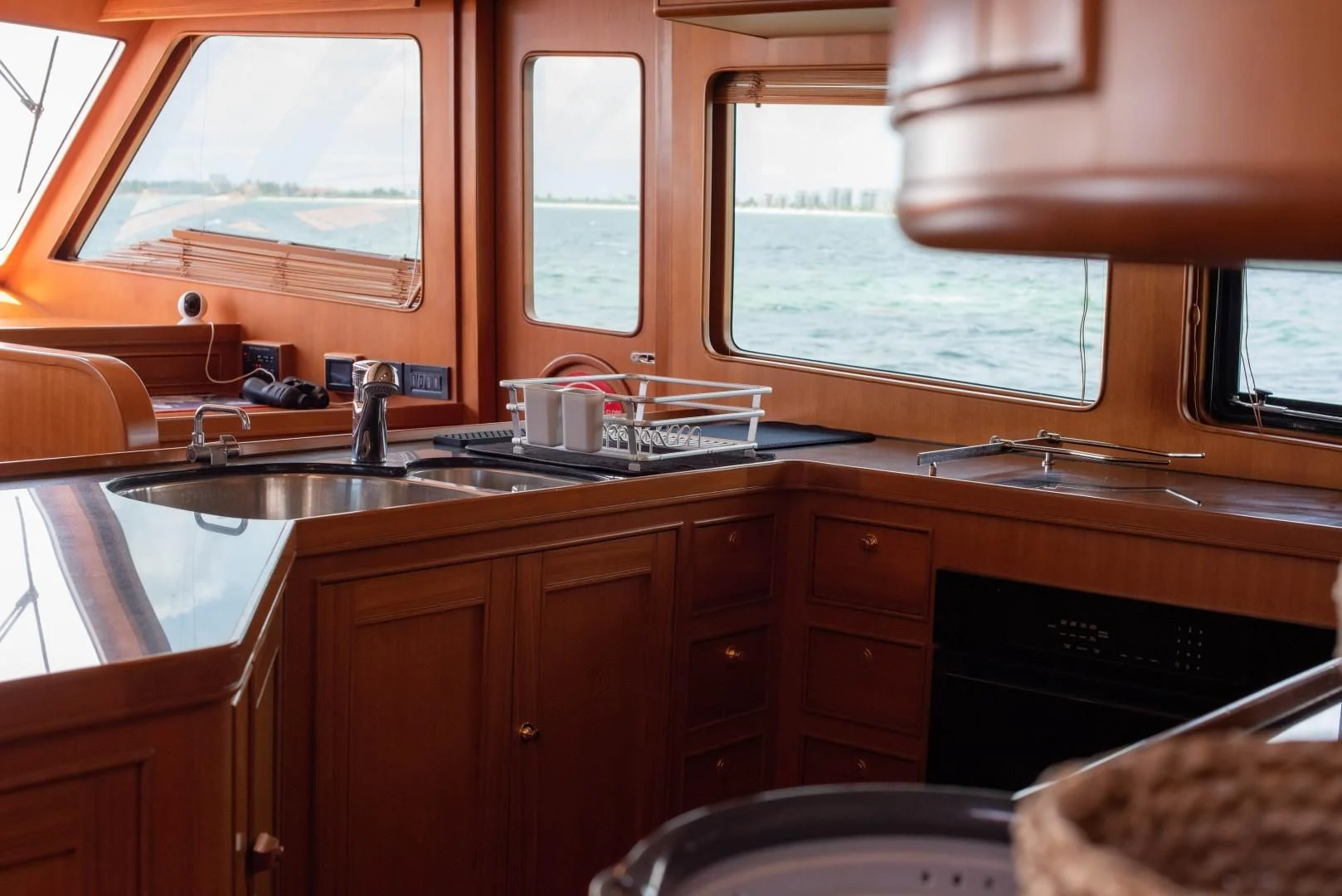 a kitchen with wooden cabinets aboard VK Yacht for Sale